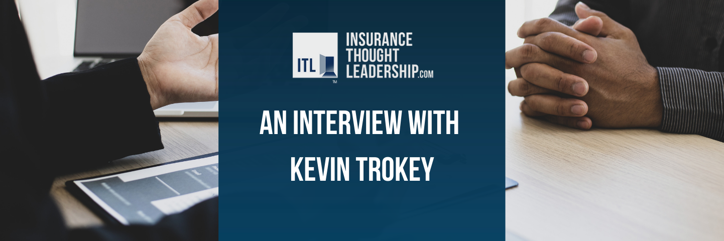 a banner reading "an interview with kevin trokey". The text is white on a blue background set against a photo of two people having a conversation.