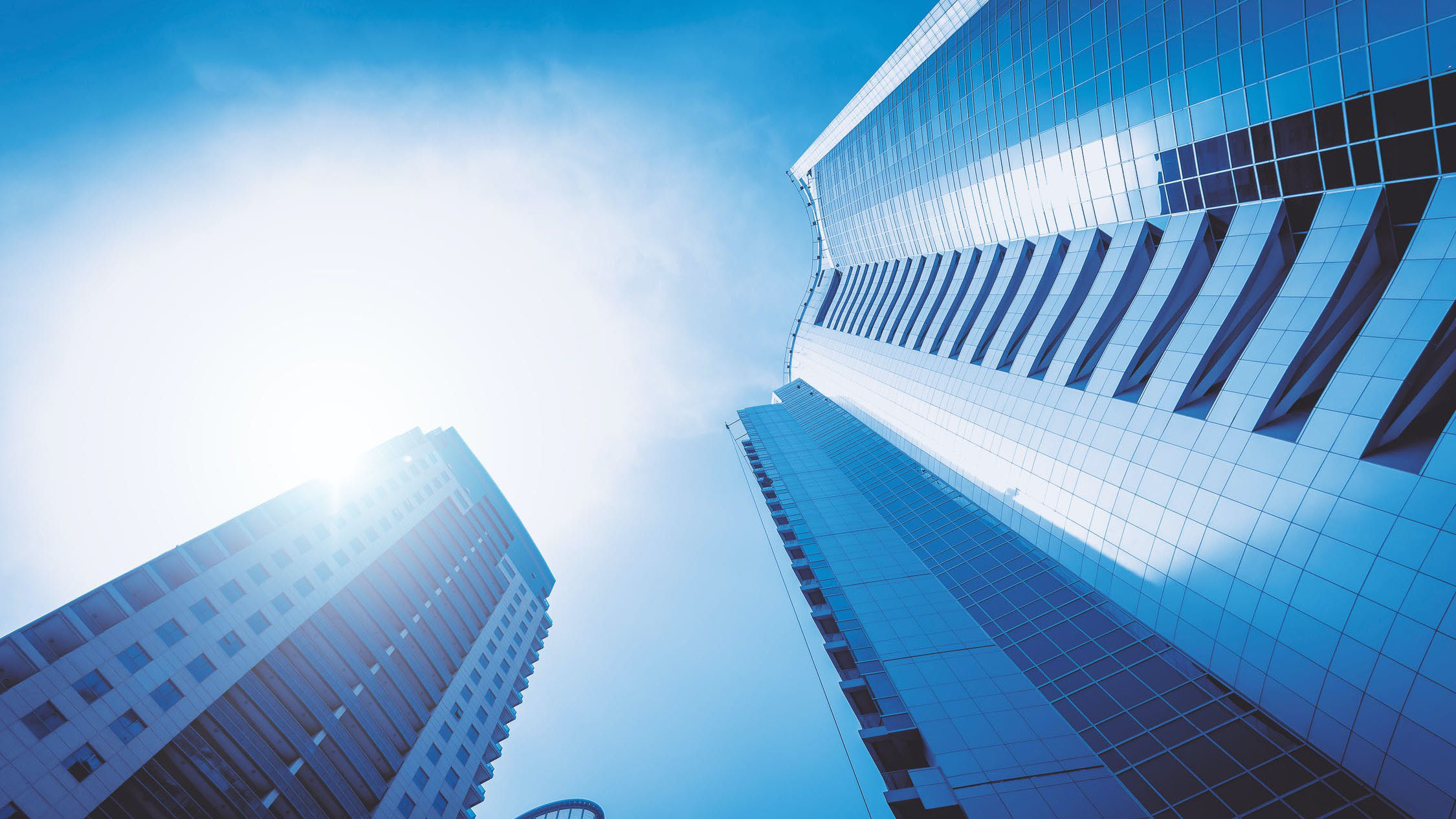 Low angle photo of tall buildings in the light