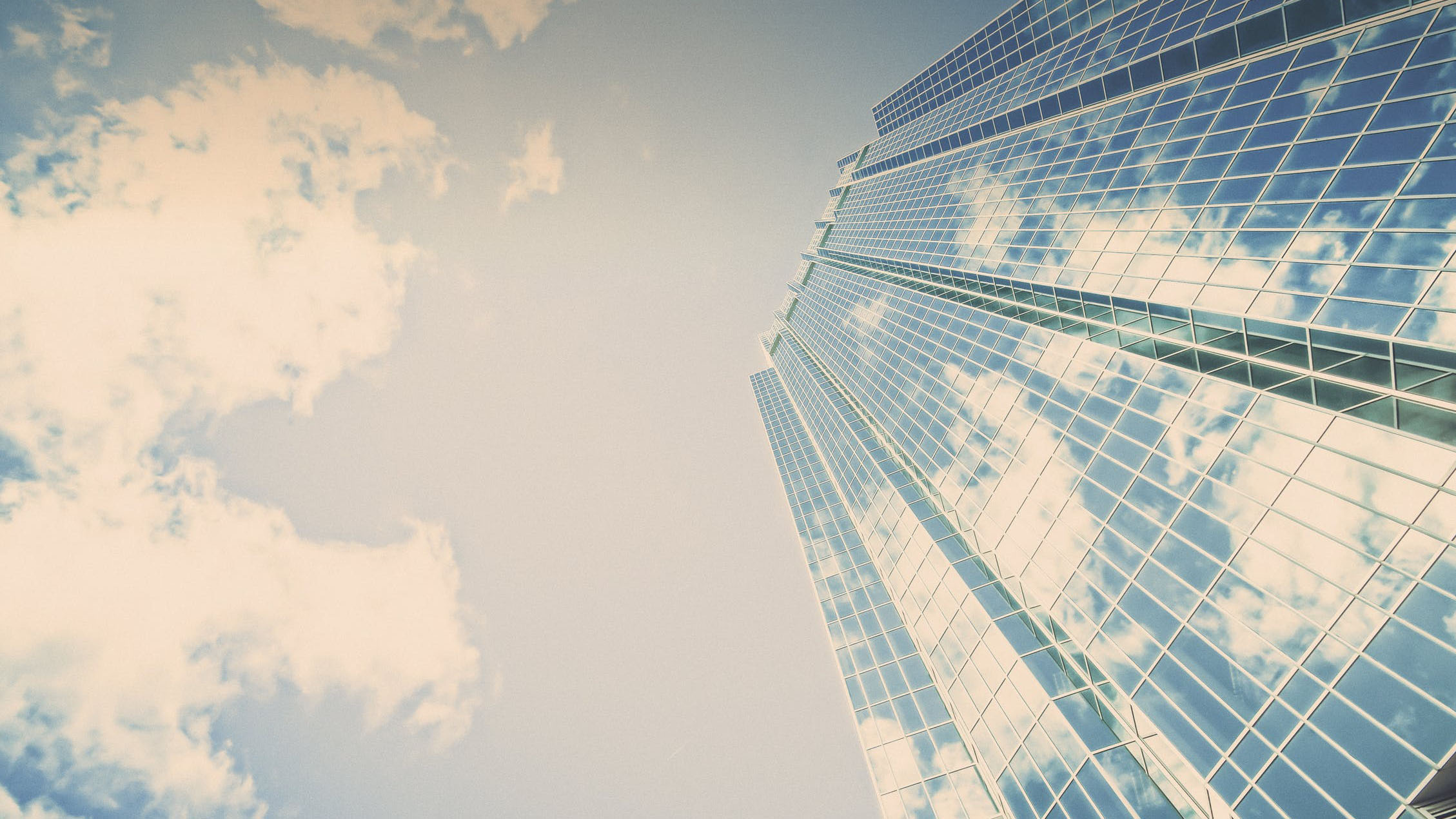 Low angle view of a tall building under sunlight