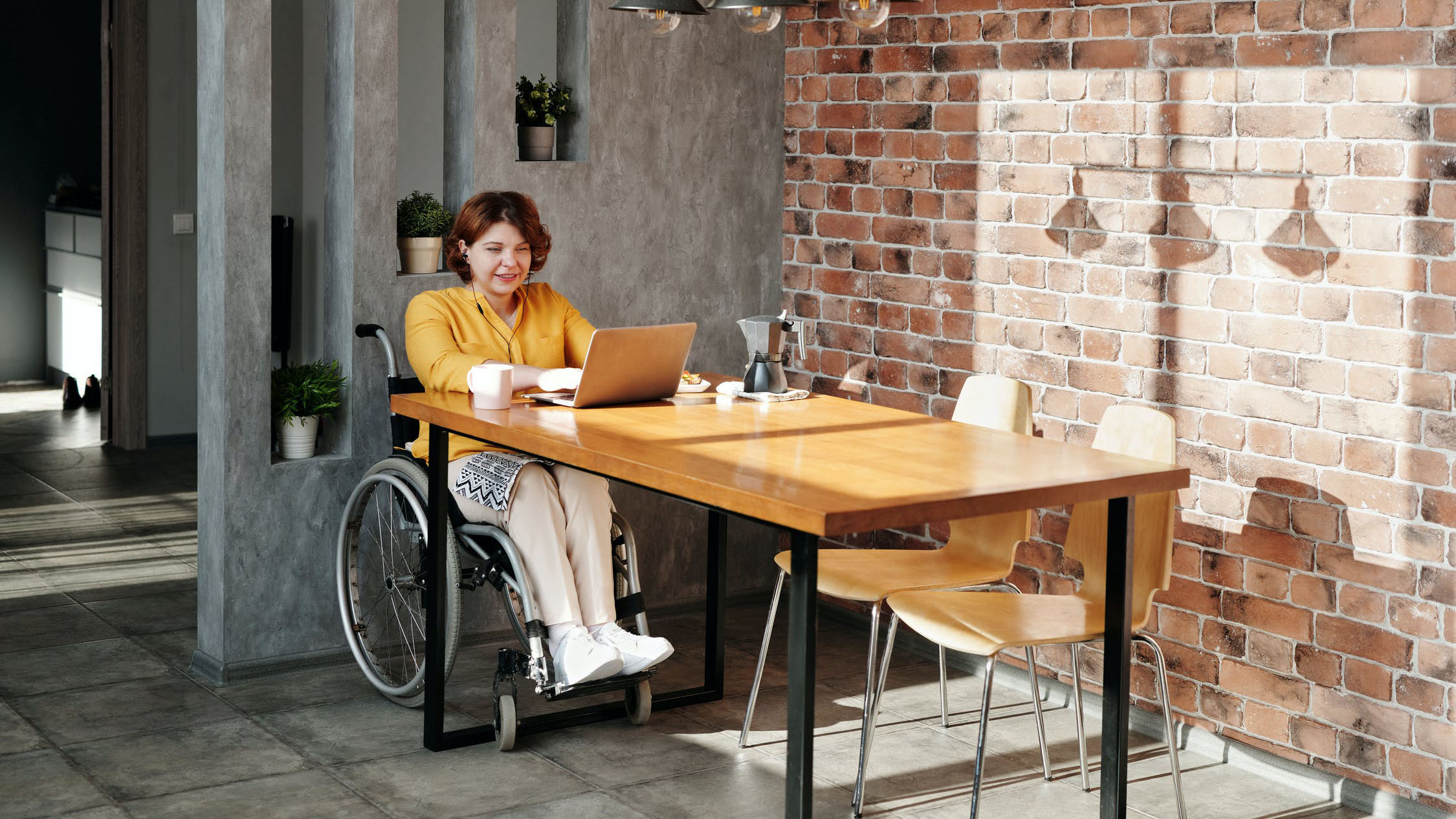 Person in a wheelchair on a laptop