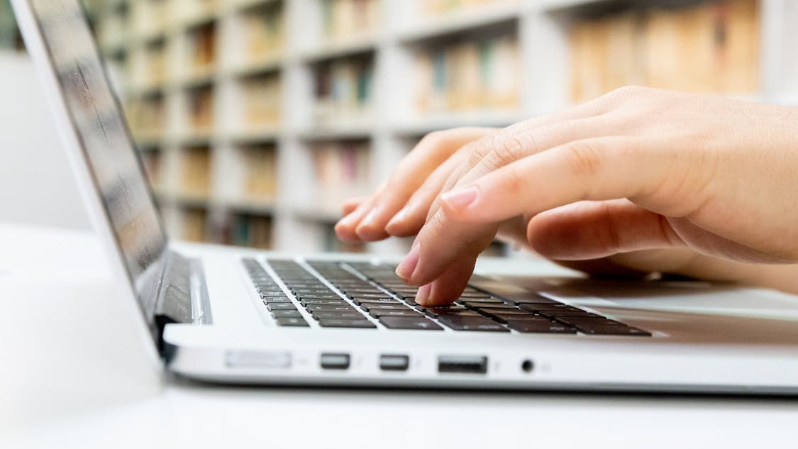 person typing on a laptop