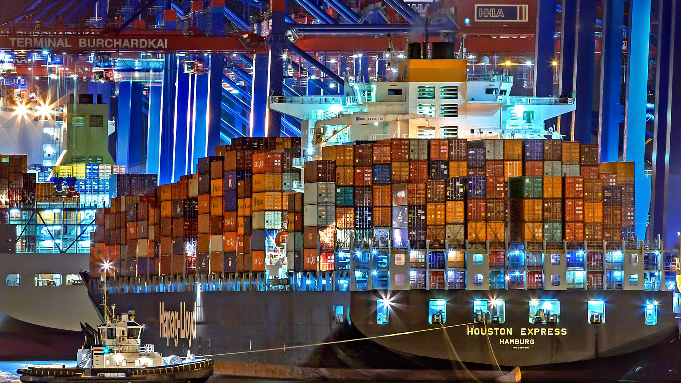 Large cargo ship full of containers at nighttime
