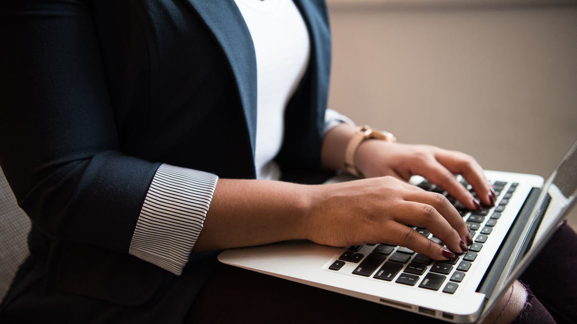 Woman typing on a laptop