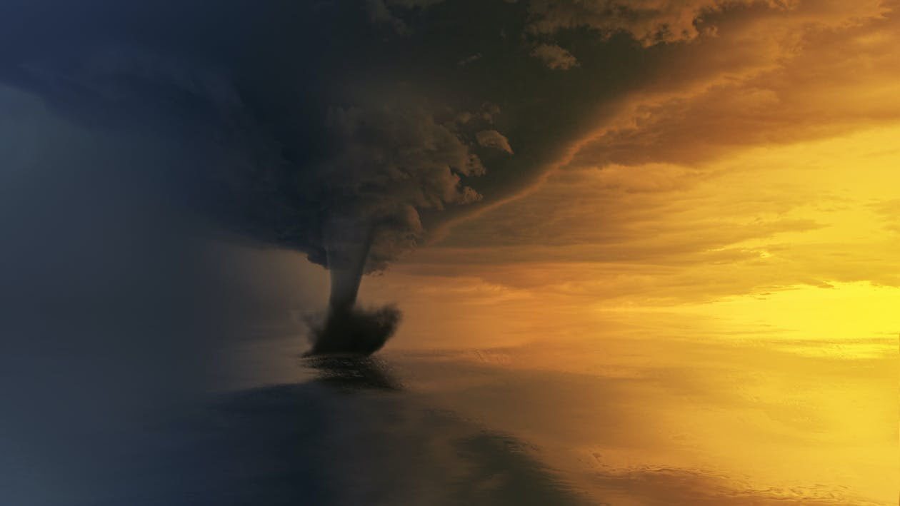 Tornado on a body of water in the distance