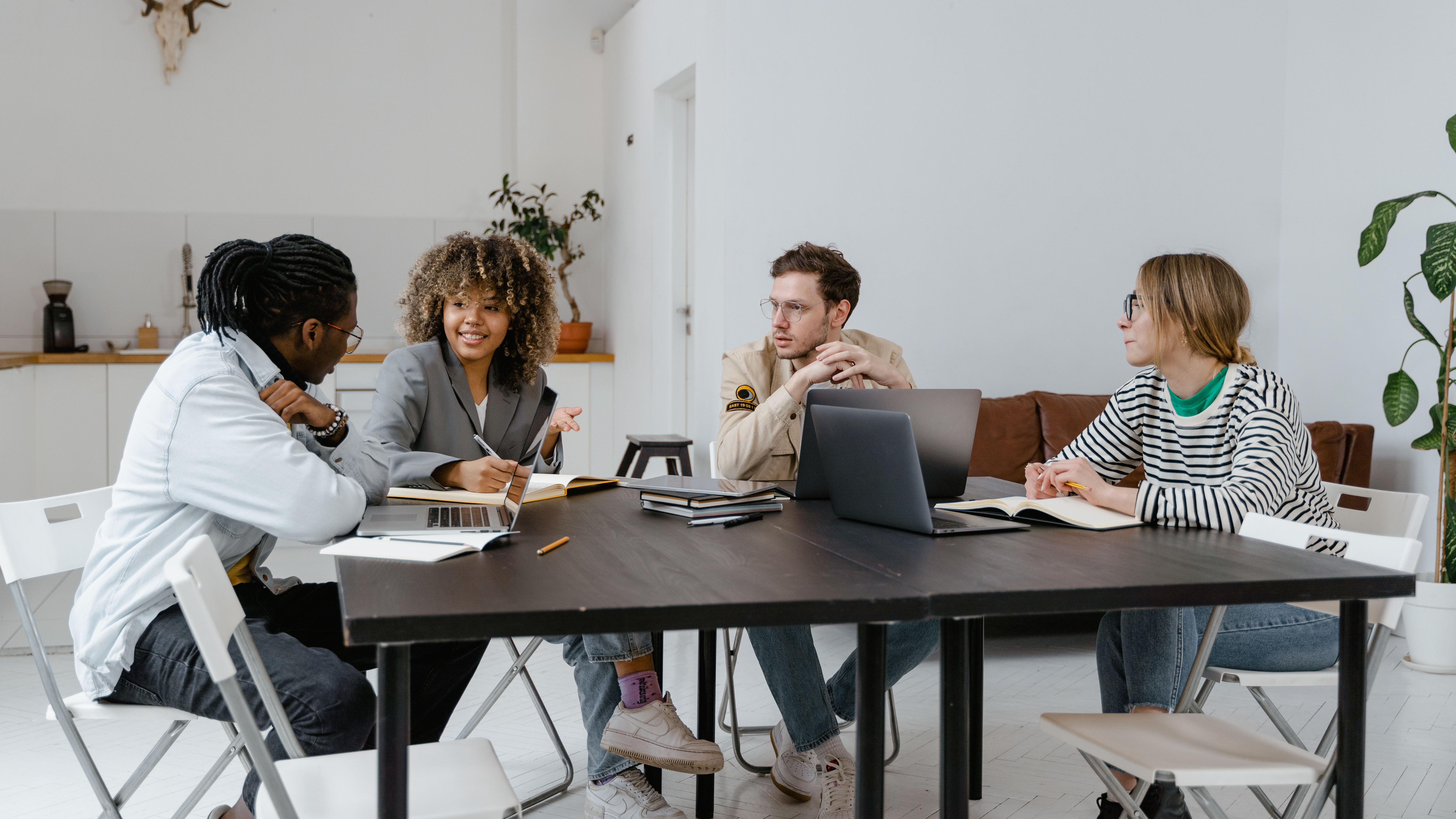 Four people around a table in a meeting