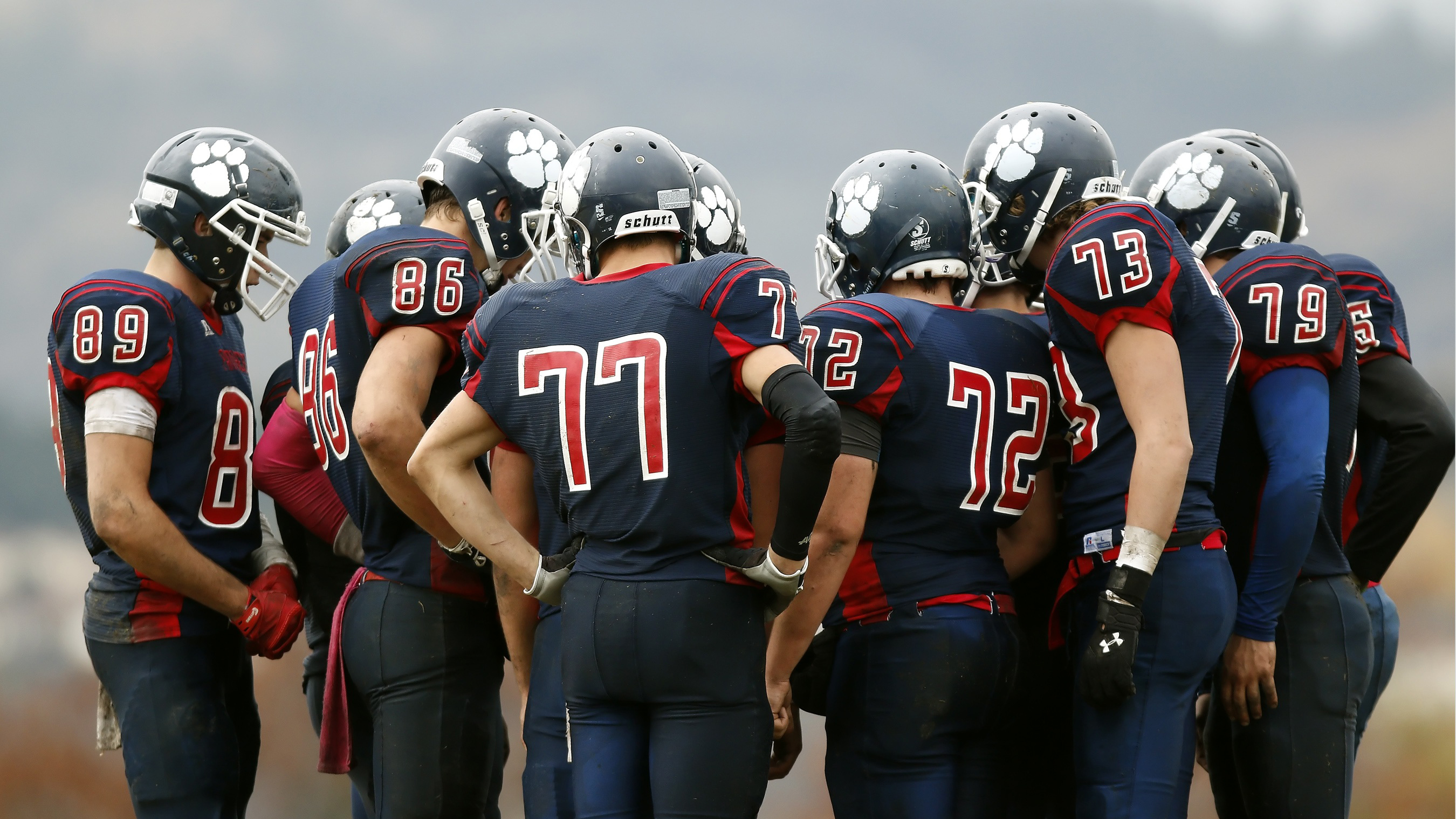 football team in a huddle