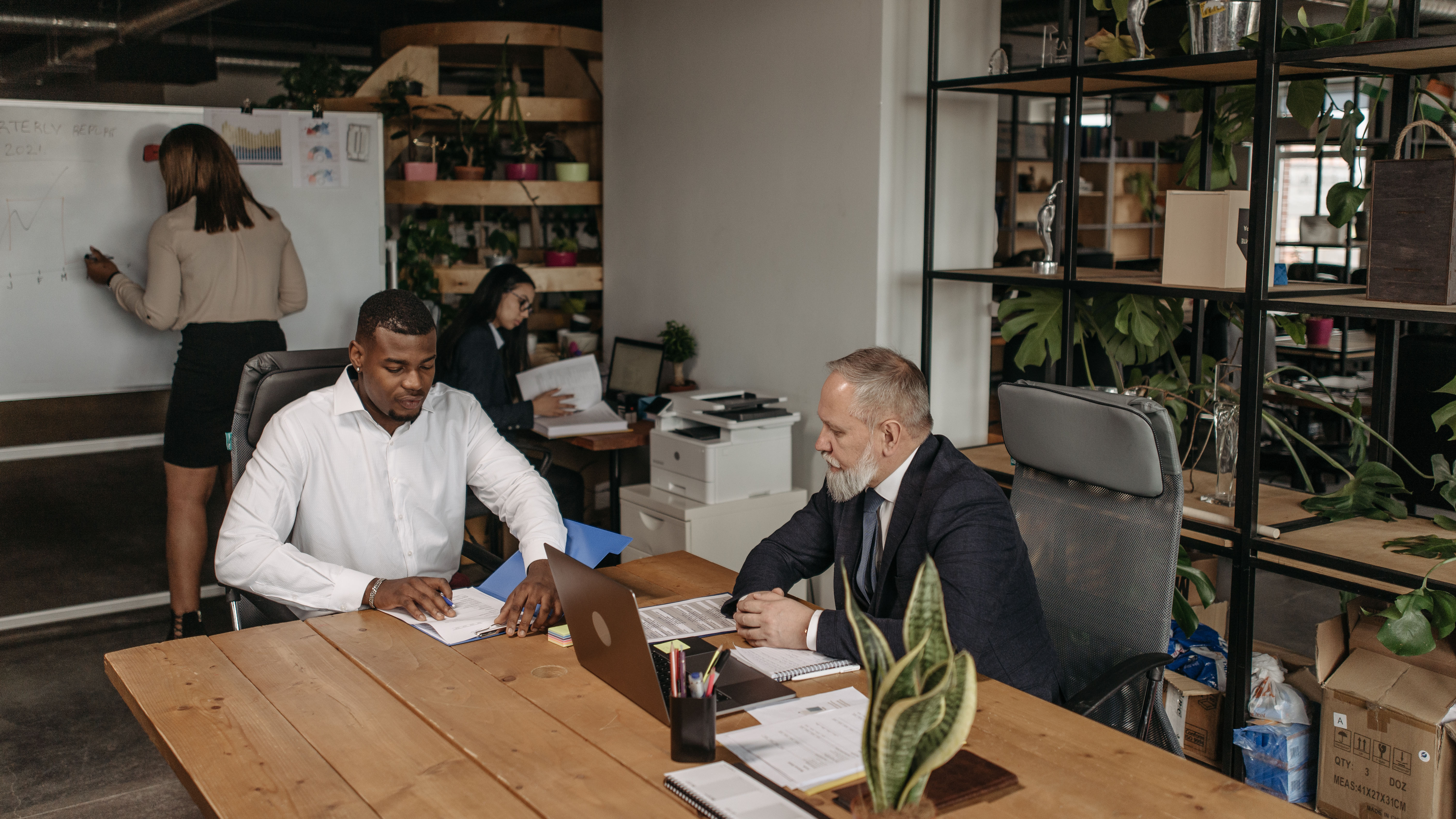 Two people sitting at a desk in an office