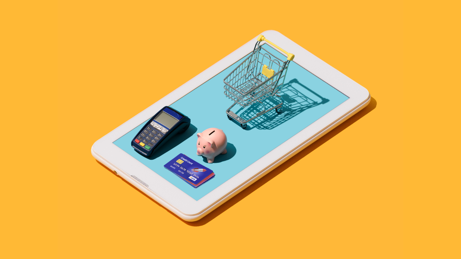an ipad with min shopping cart, credit card, credit card machine and piggy bank on it. There is a yellow background. 