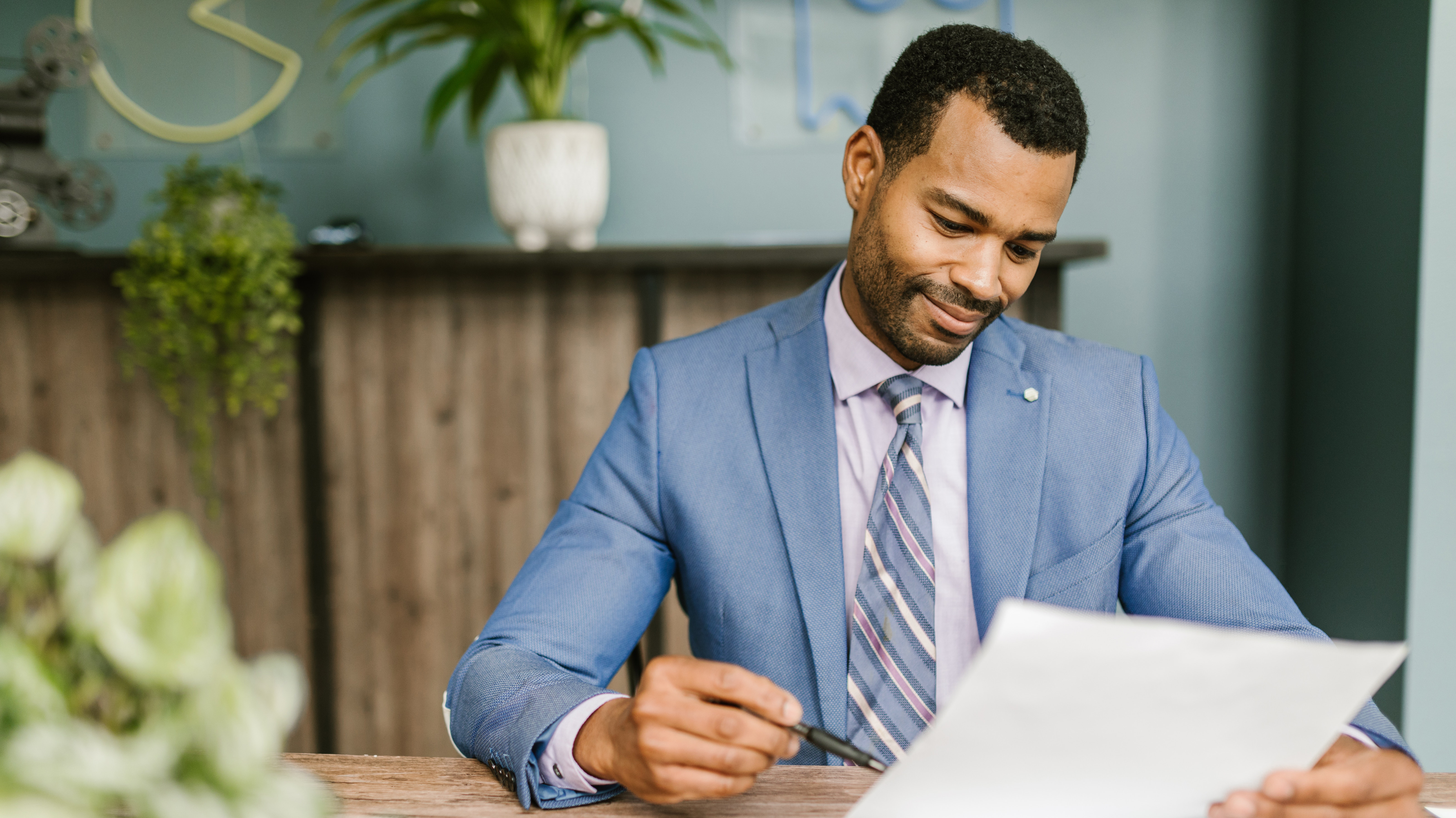 Man at a desk looking at a piece of paper