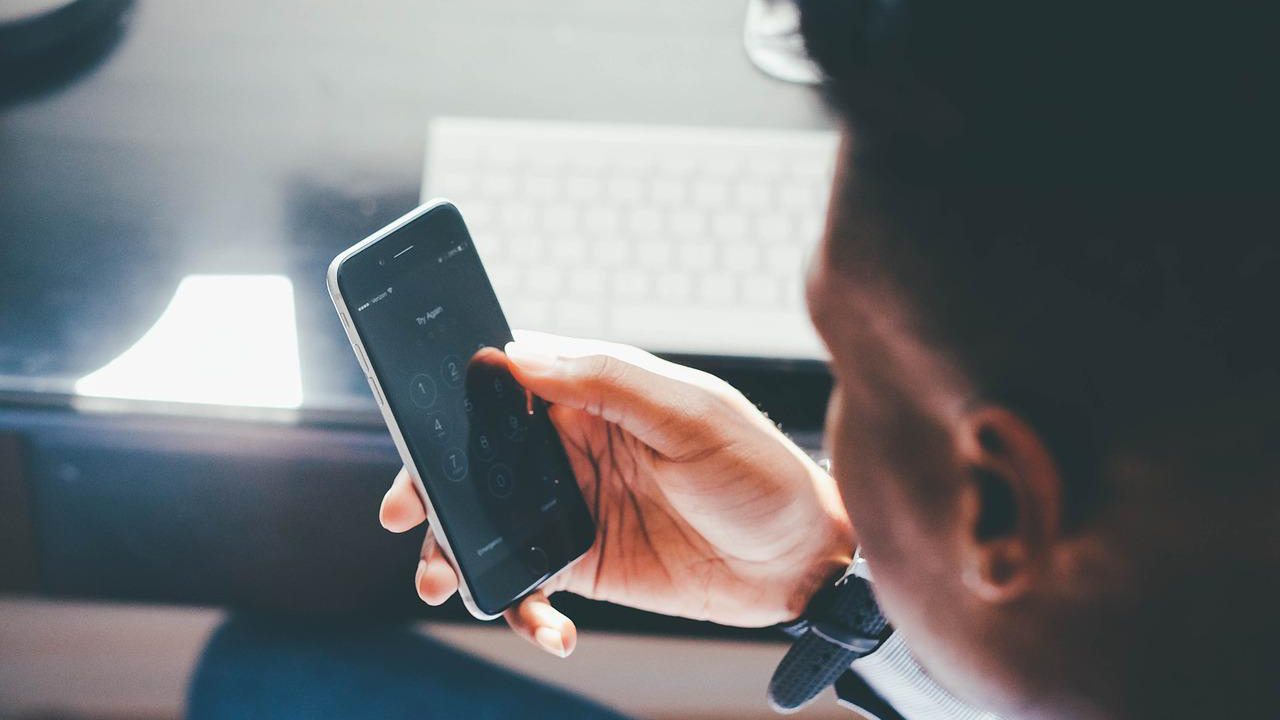 Man on his phone while sitting down