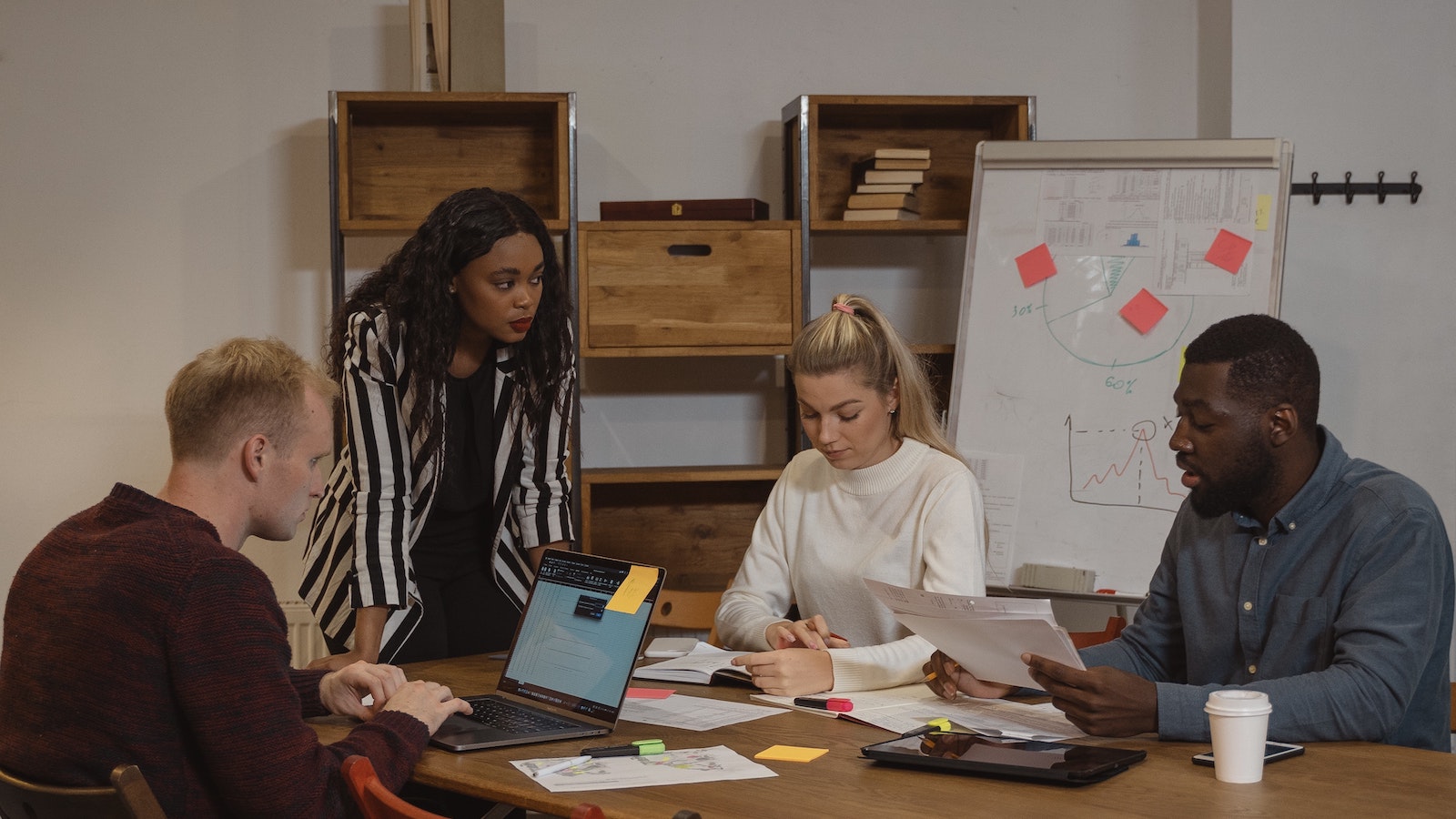 Four people strategize in an office setting
