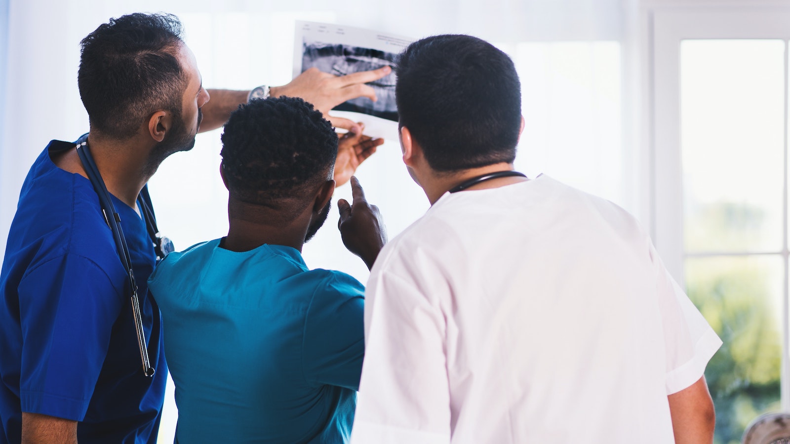 Doctors showing a patient an x-ray