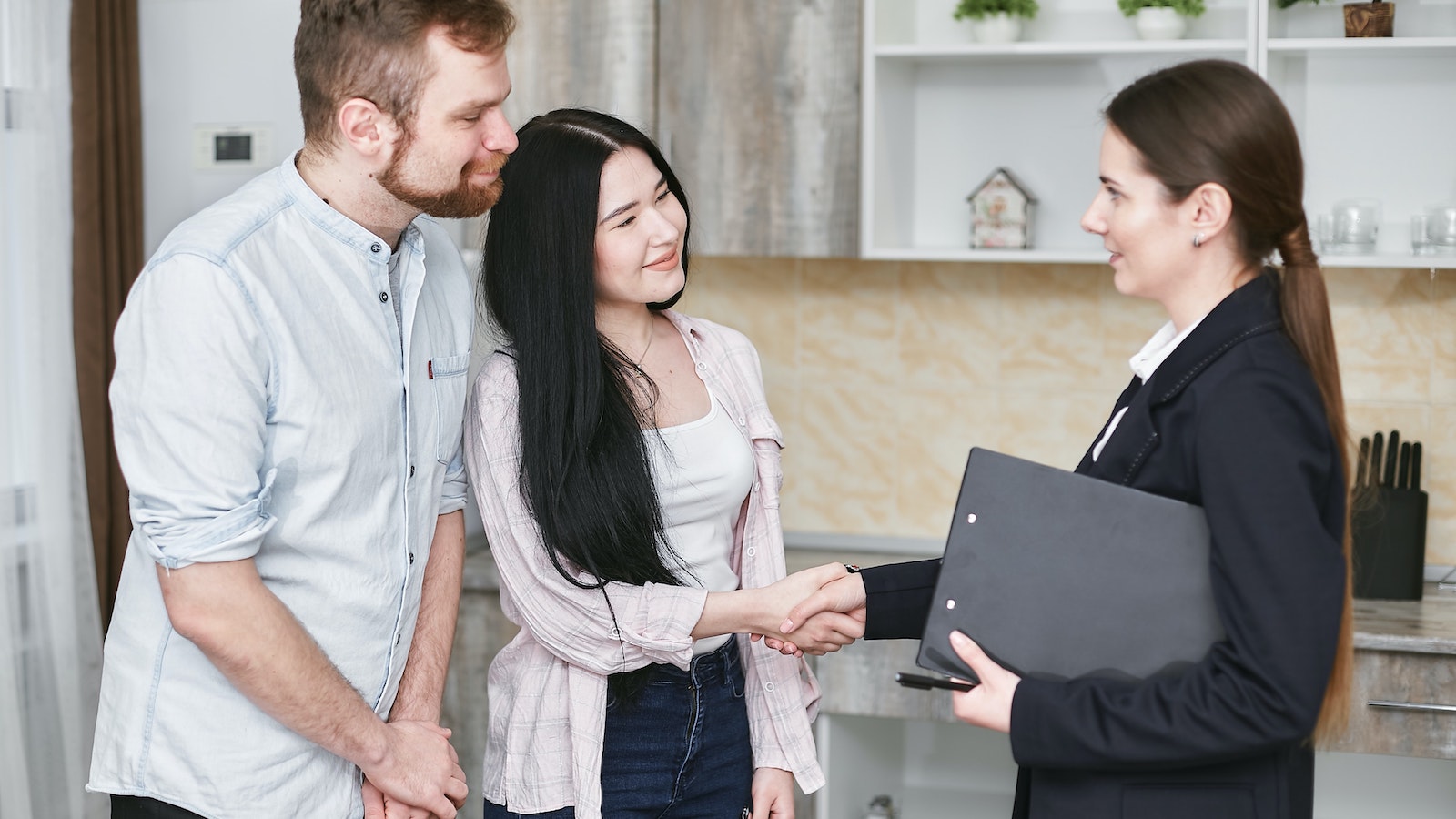 Woman in suit shaking hands with a client