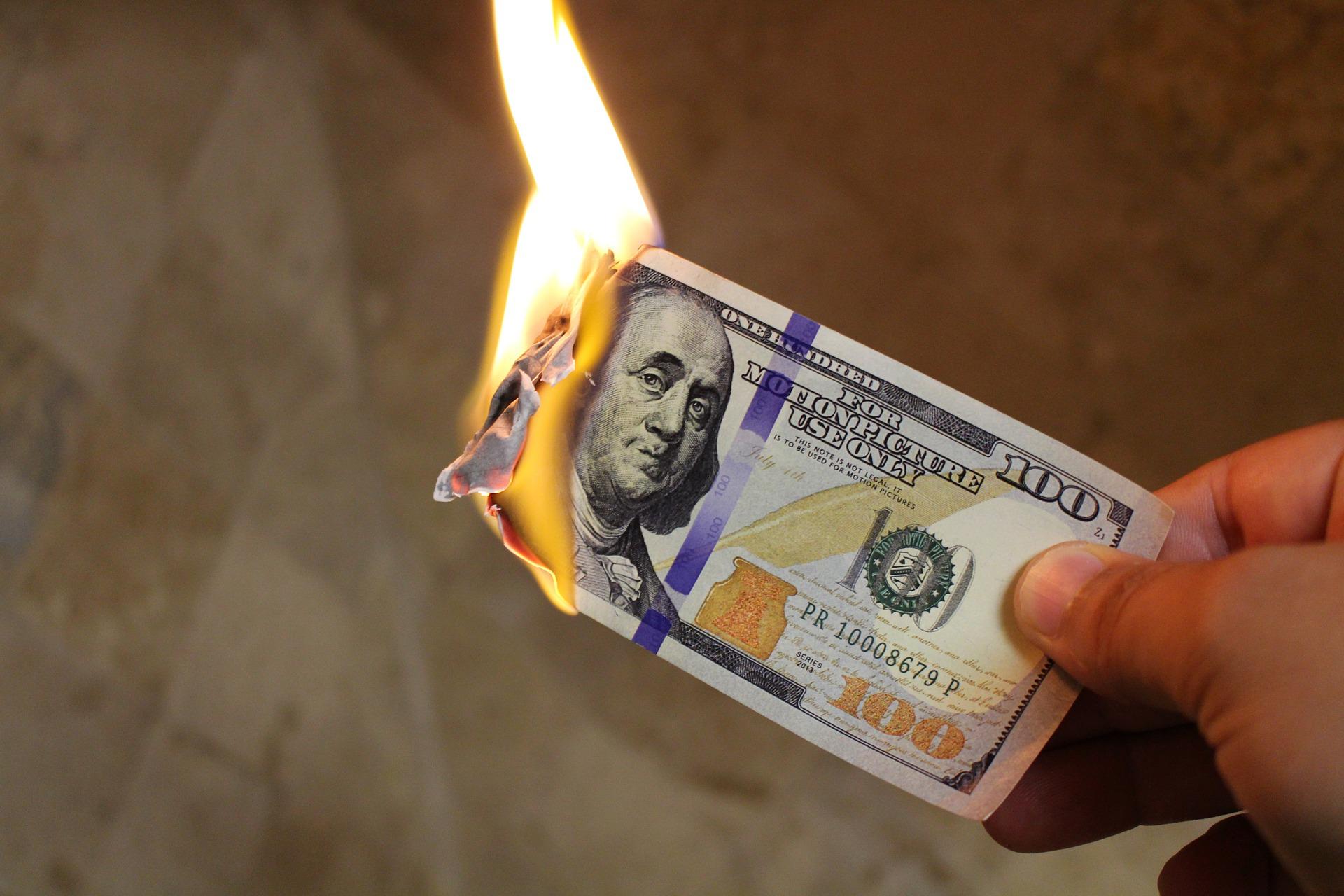 Hundred dollar bill on fire