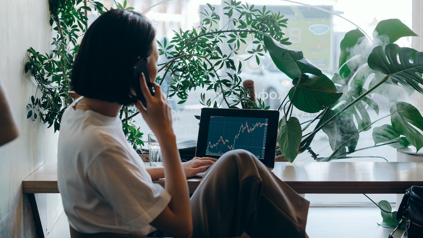 A woman on the phone looking at a graph