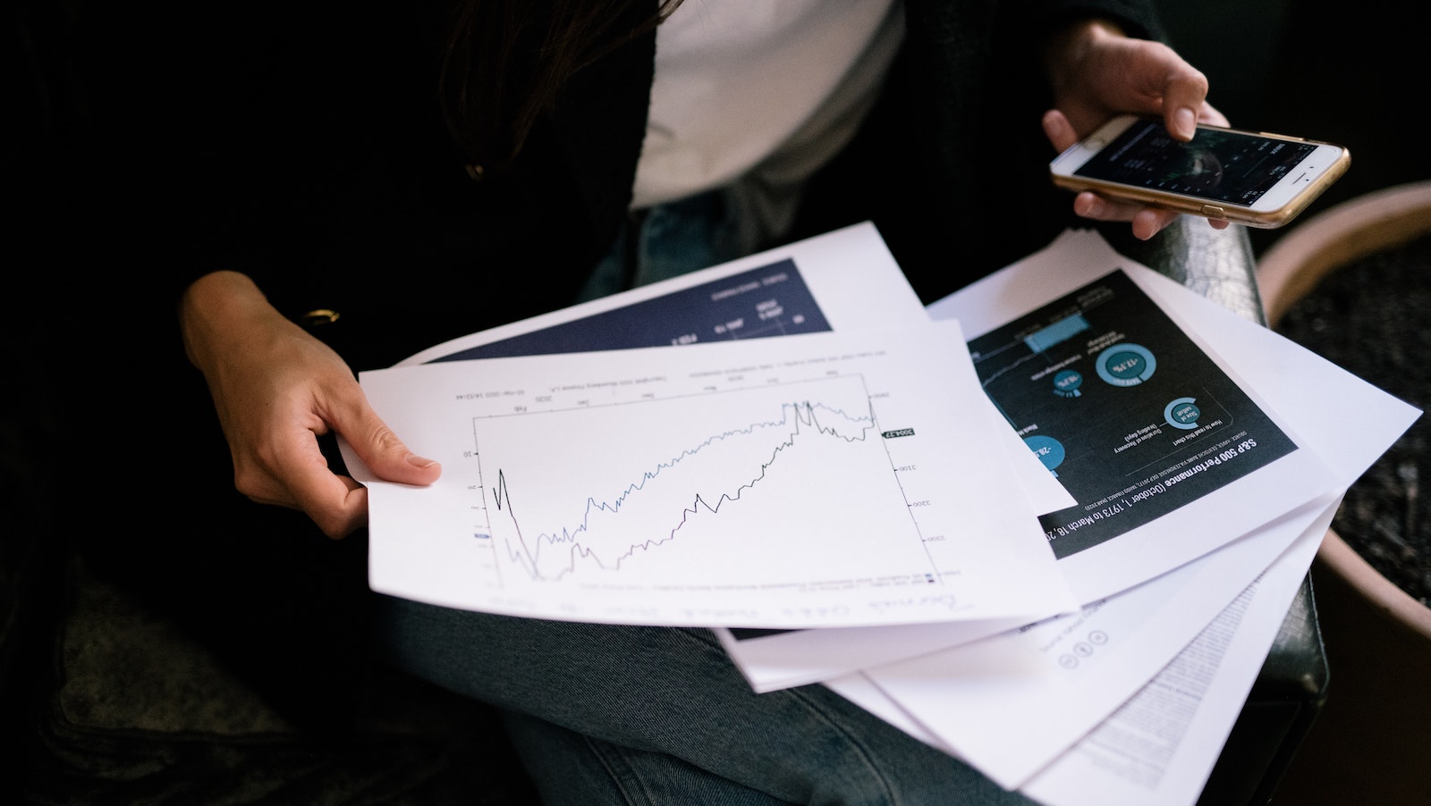 Person holding graphs that have been printed 