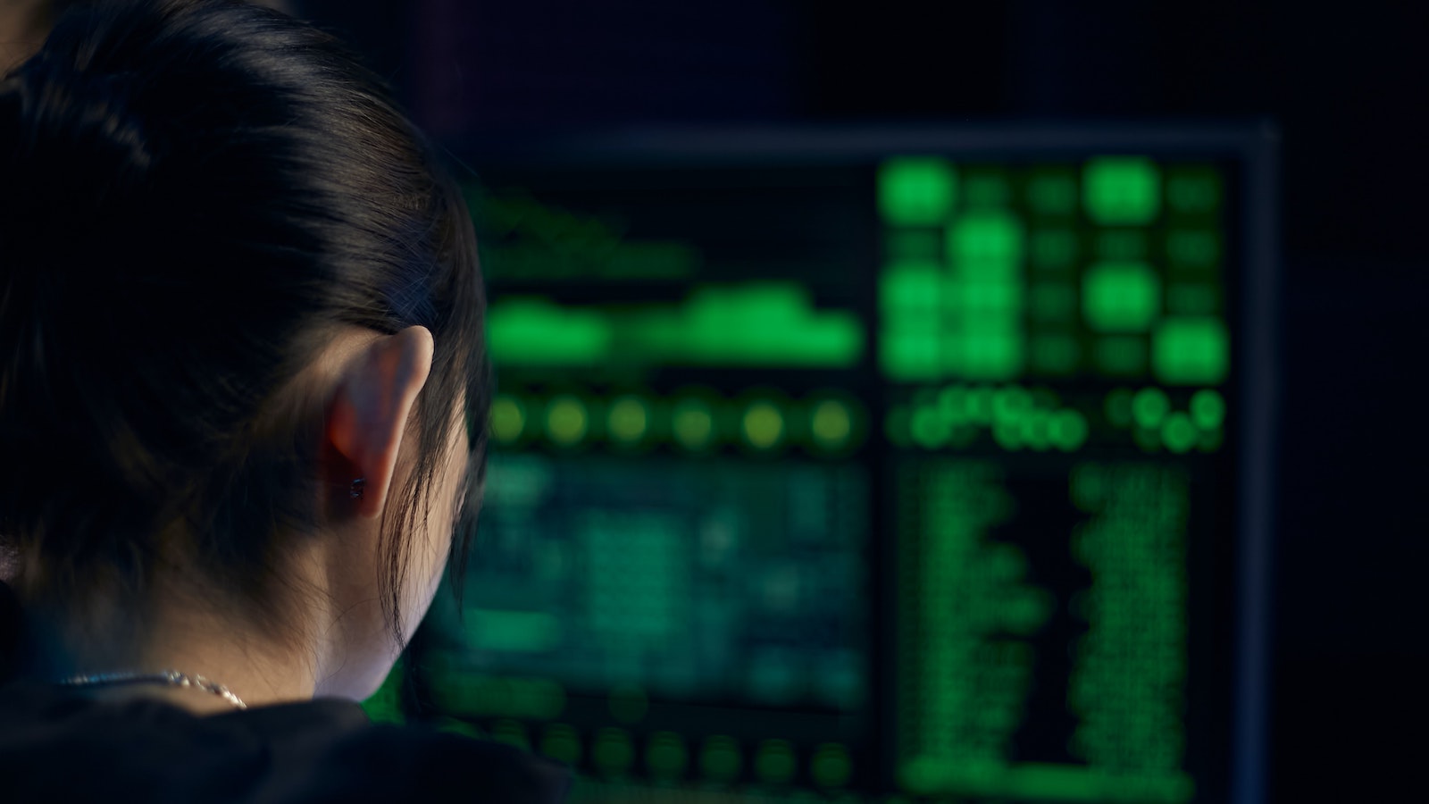 Woman in black shirt looking at neon lights