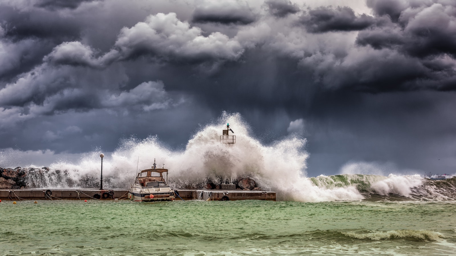 Boat and dock being hit by a strong wave