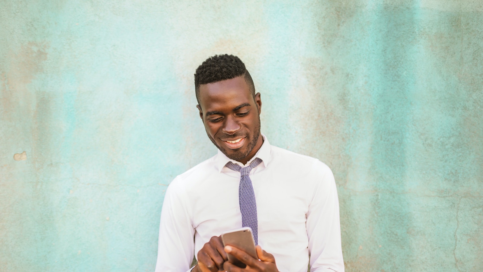 Person holding phone in front of wall