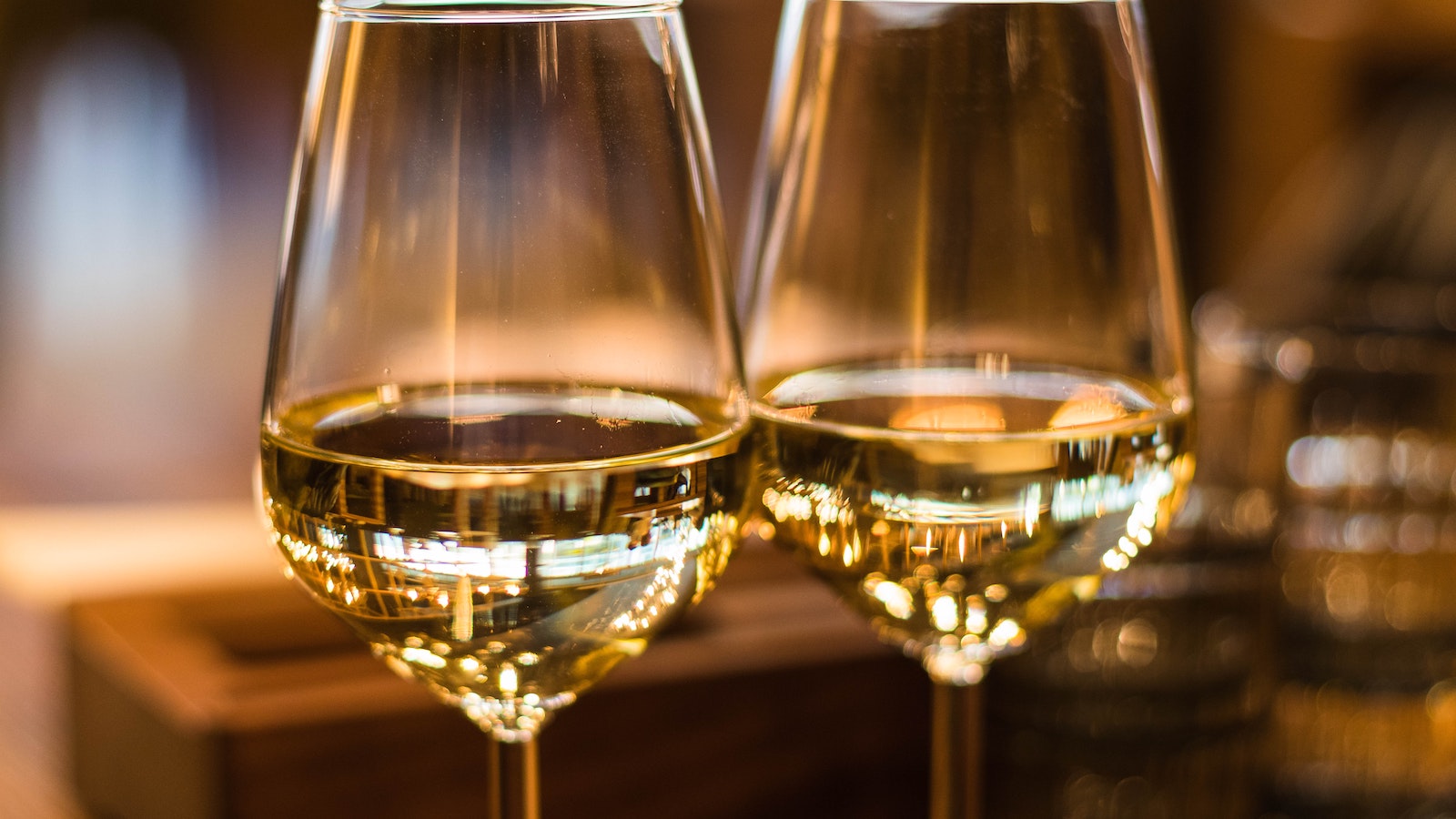 Two wine glasses filled with white wine