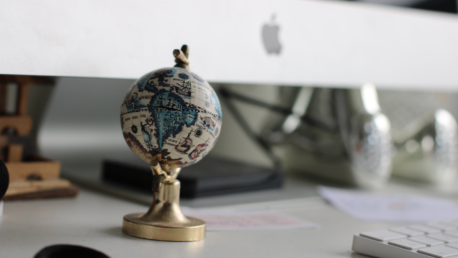 Small globe in front of a computer