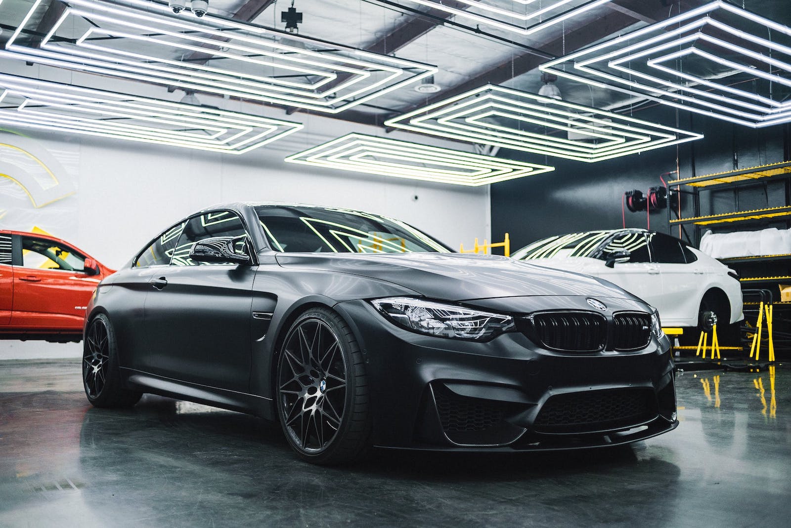 three cars in a car shop indoors