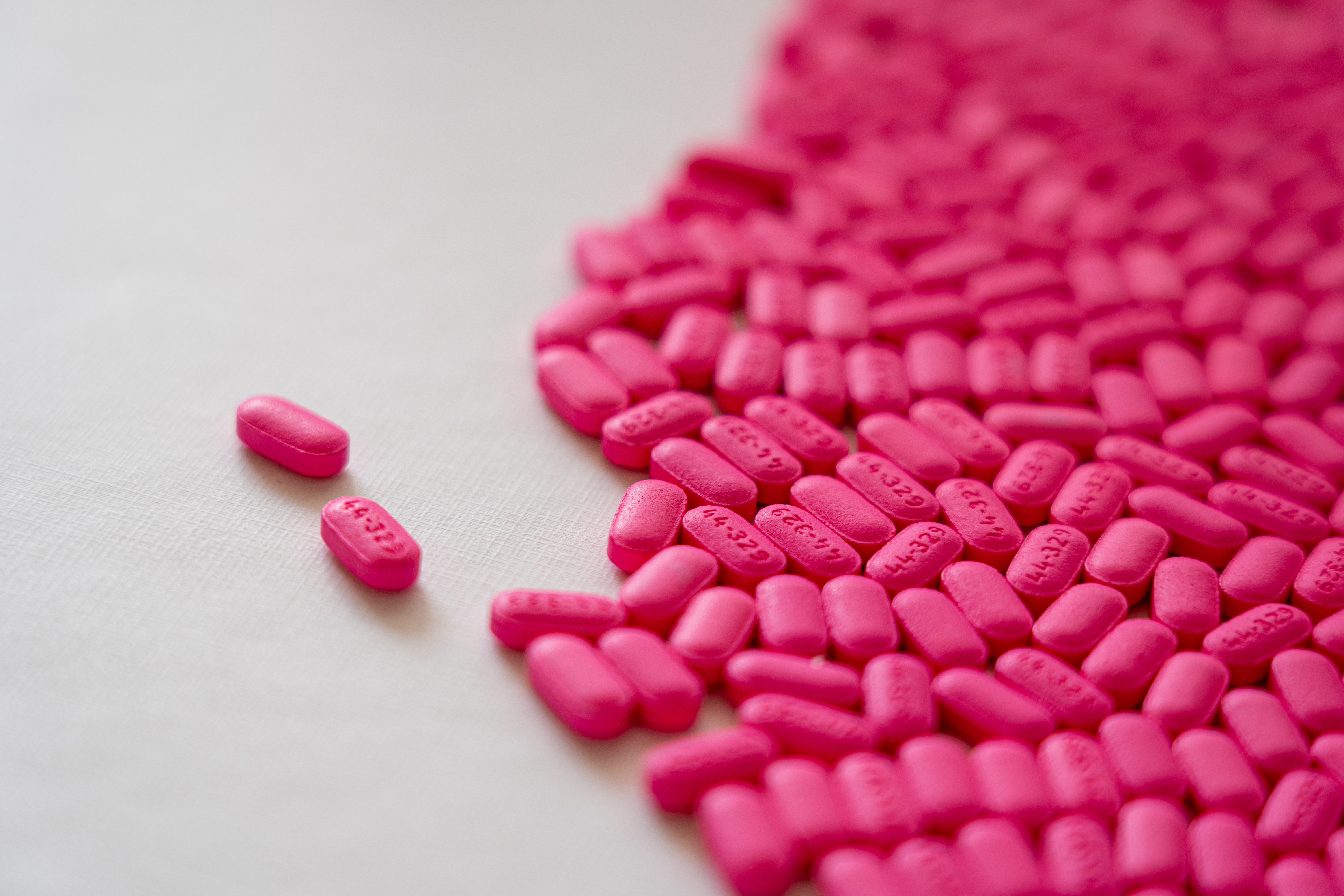 Pink prescription medications on a counter