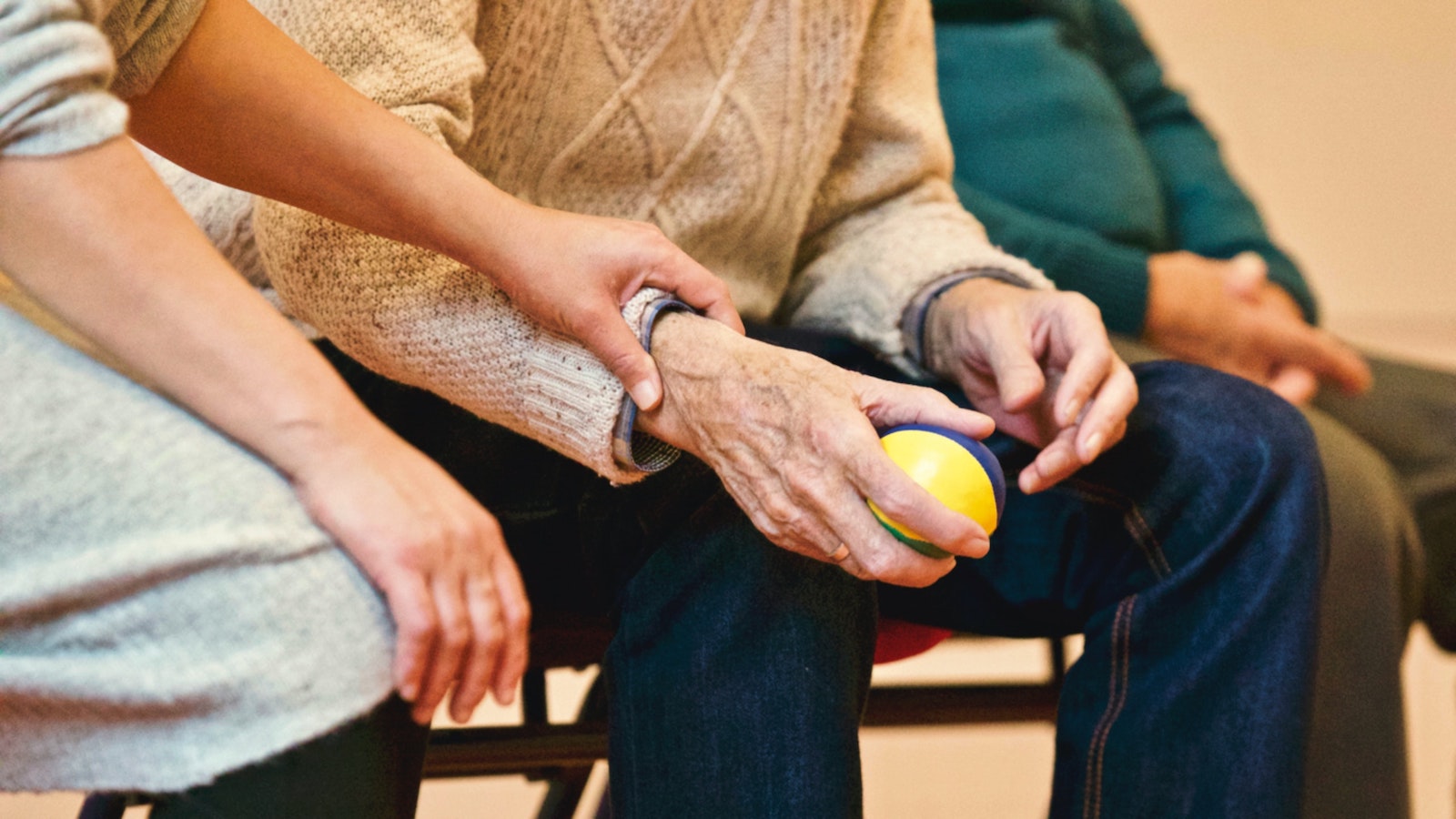 Person holding the wrist of an elderly person