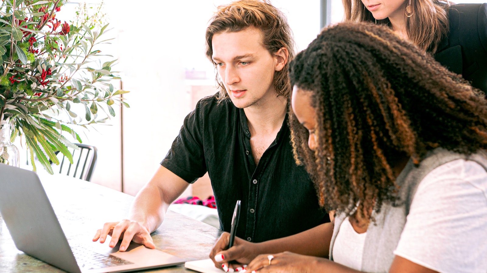 People looking at a computer together