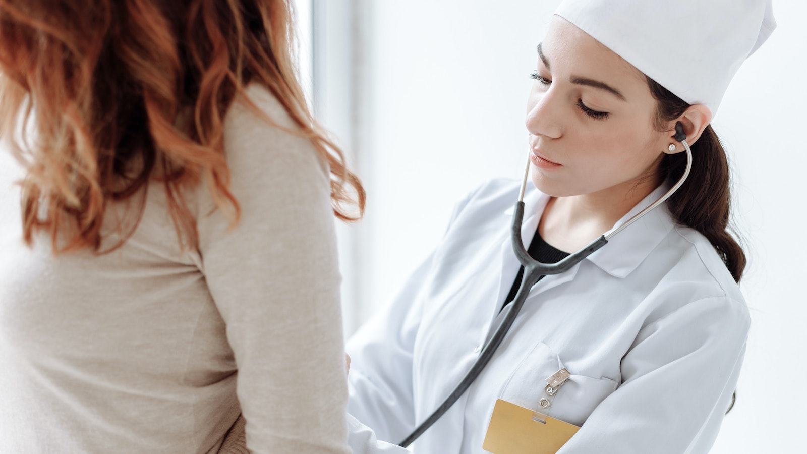 Photo of a doctor checking on her patient