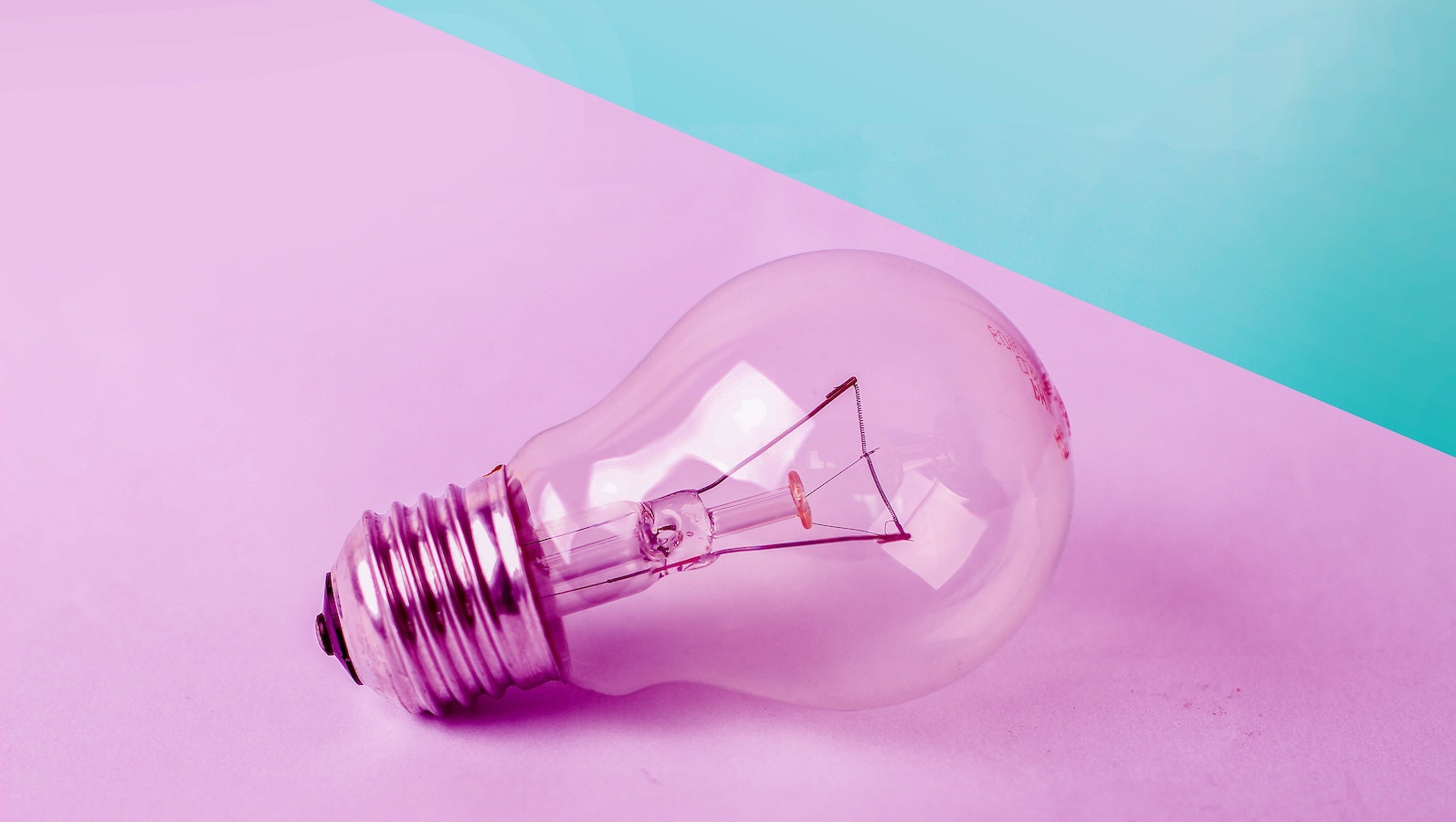 Light bulb on a pink and blue background