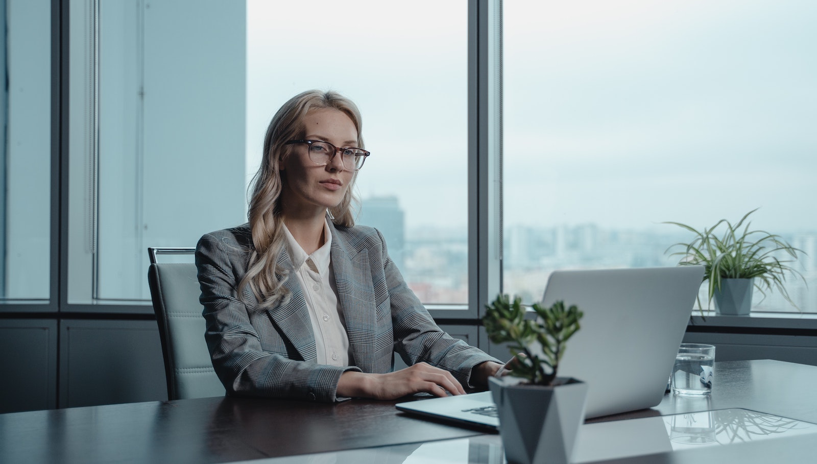 Woman sitting at a desk in front of a computer in an office building