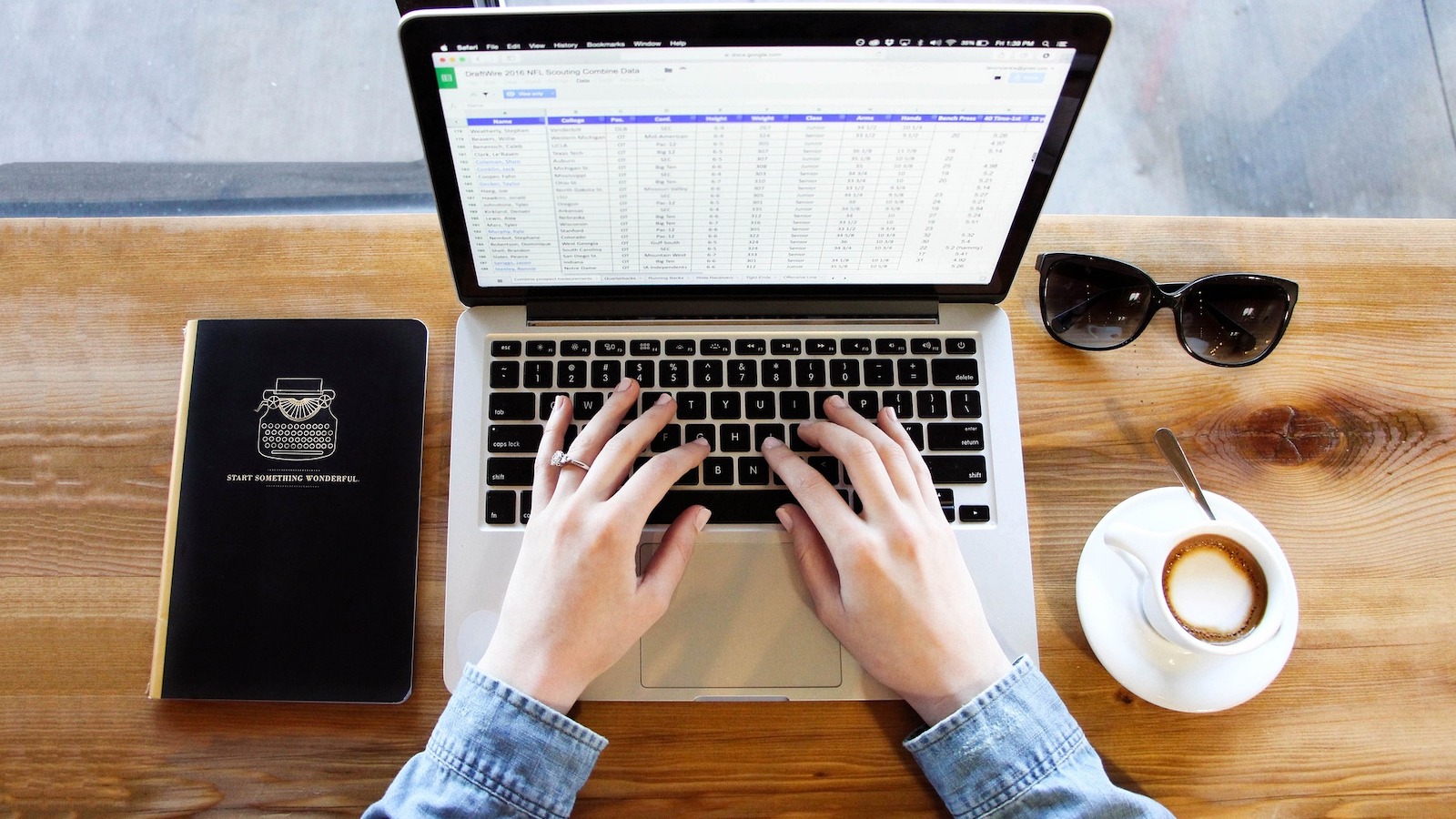 Person typing on a computer with a spreadsheet open