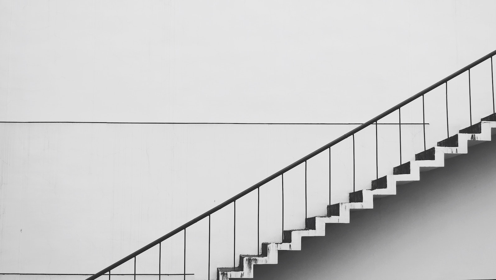 Staircase against a white building