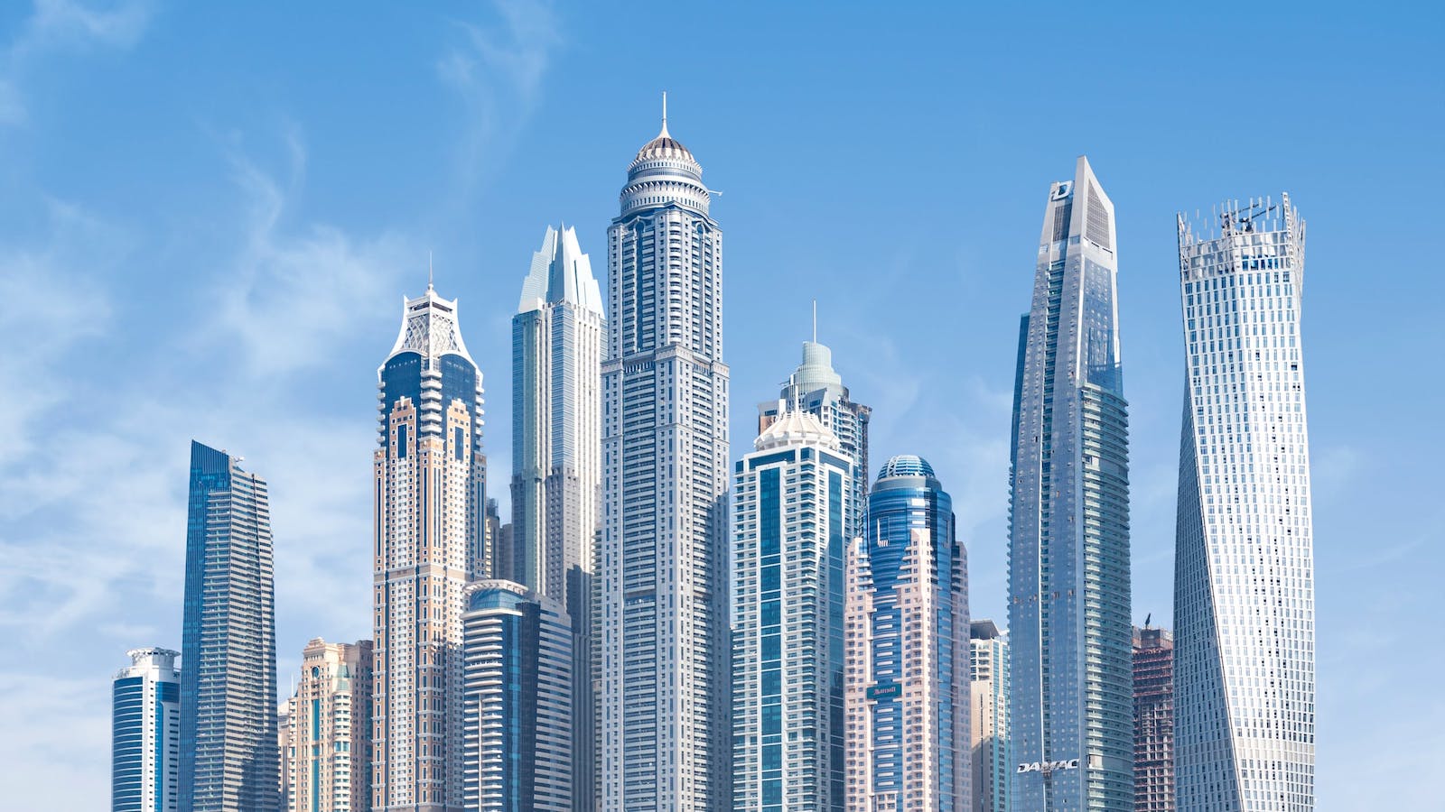 Tall skyscrapers clustered together and across a blue sky