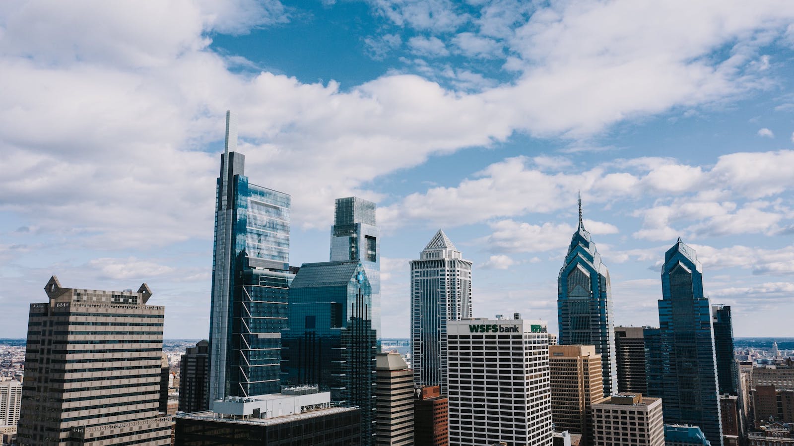 City skyline across a blue and cloudy sky