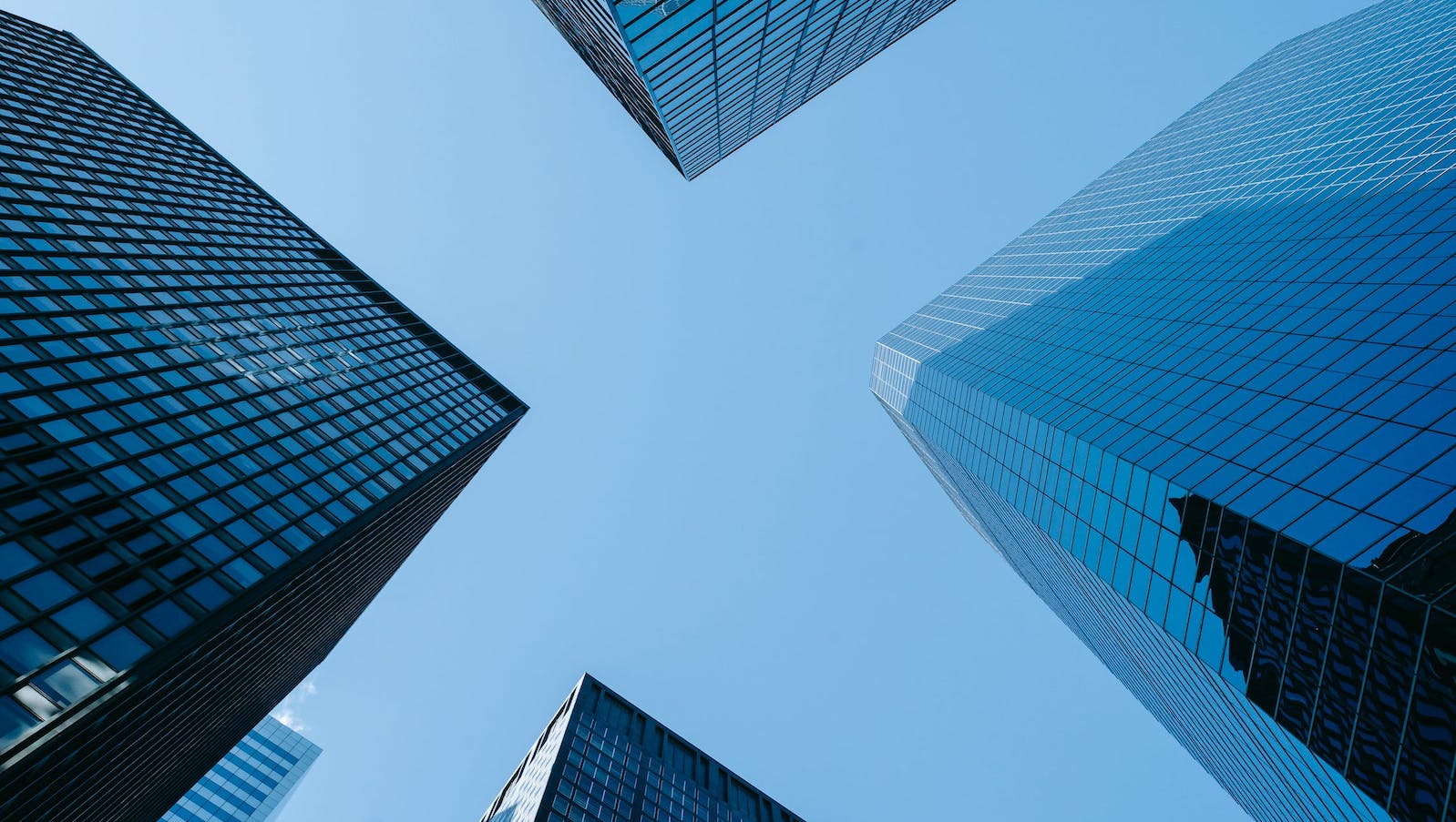 Low angle photo of tall building against a blue sky