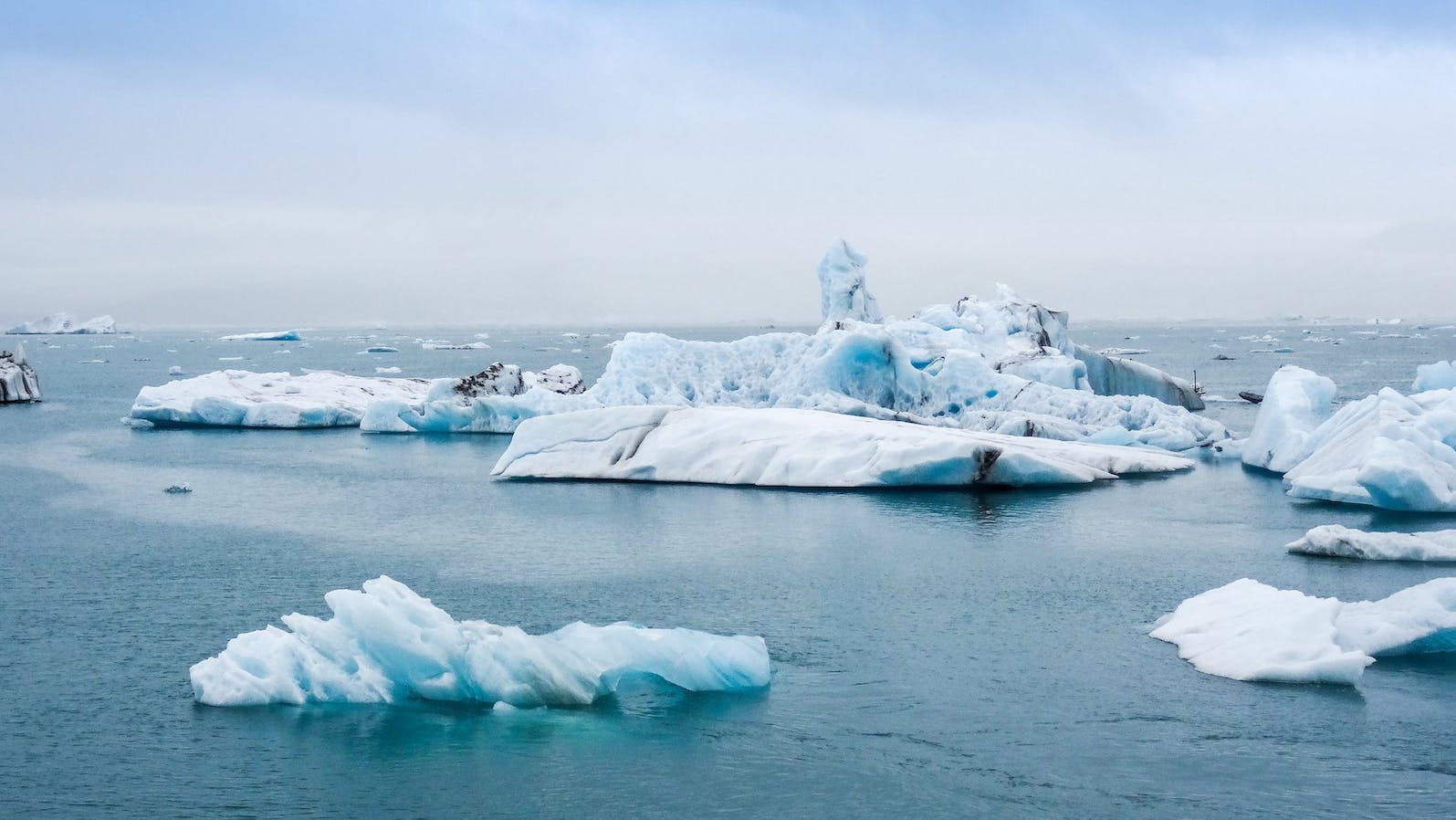 Icebergs in the ocean under a blue sky