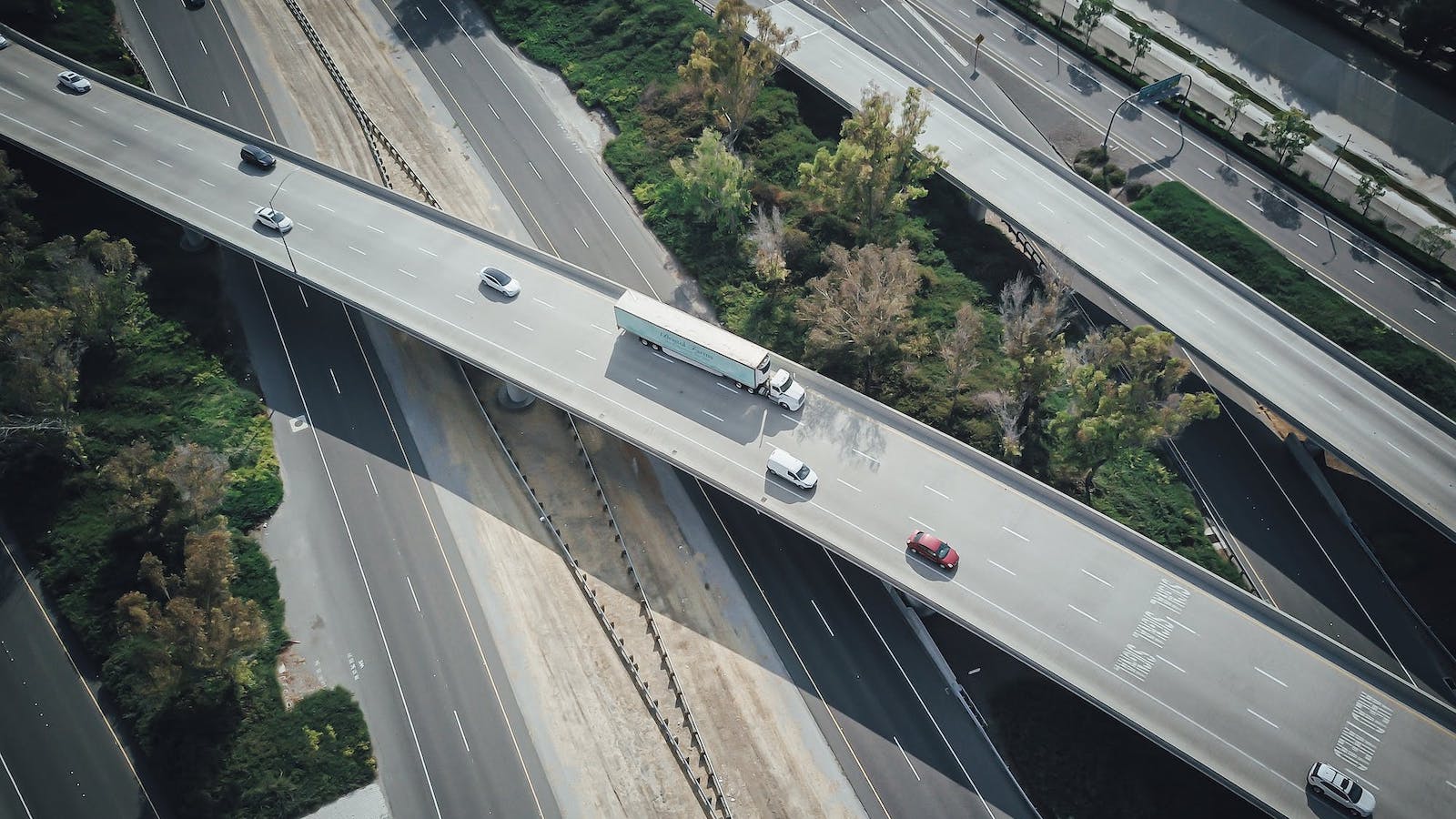 Overhead view of a freeway with several cars driving on it