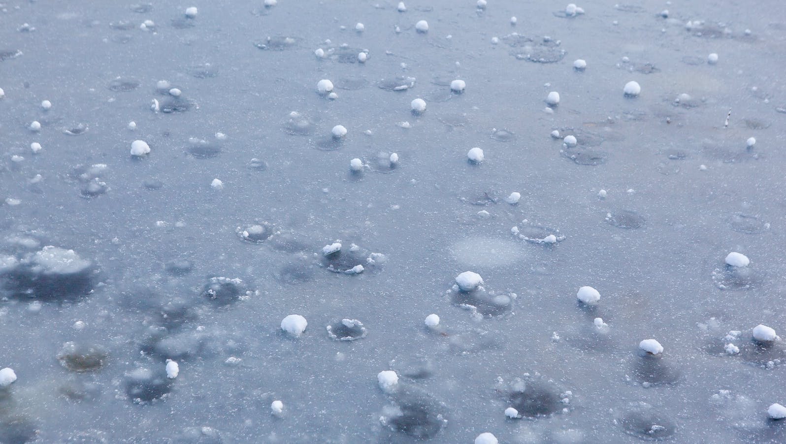 Hail Balls After Heavy Rain Lying on Ice