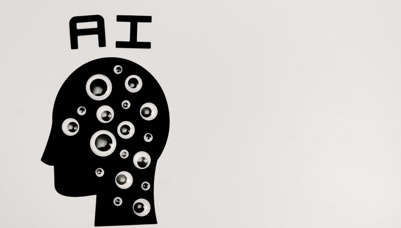 An image of a black side profile drawing against a gray background with the letters "AI" above the head