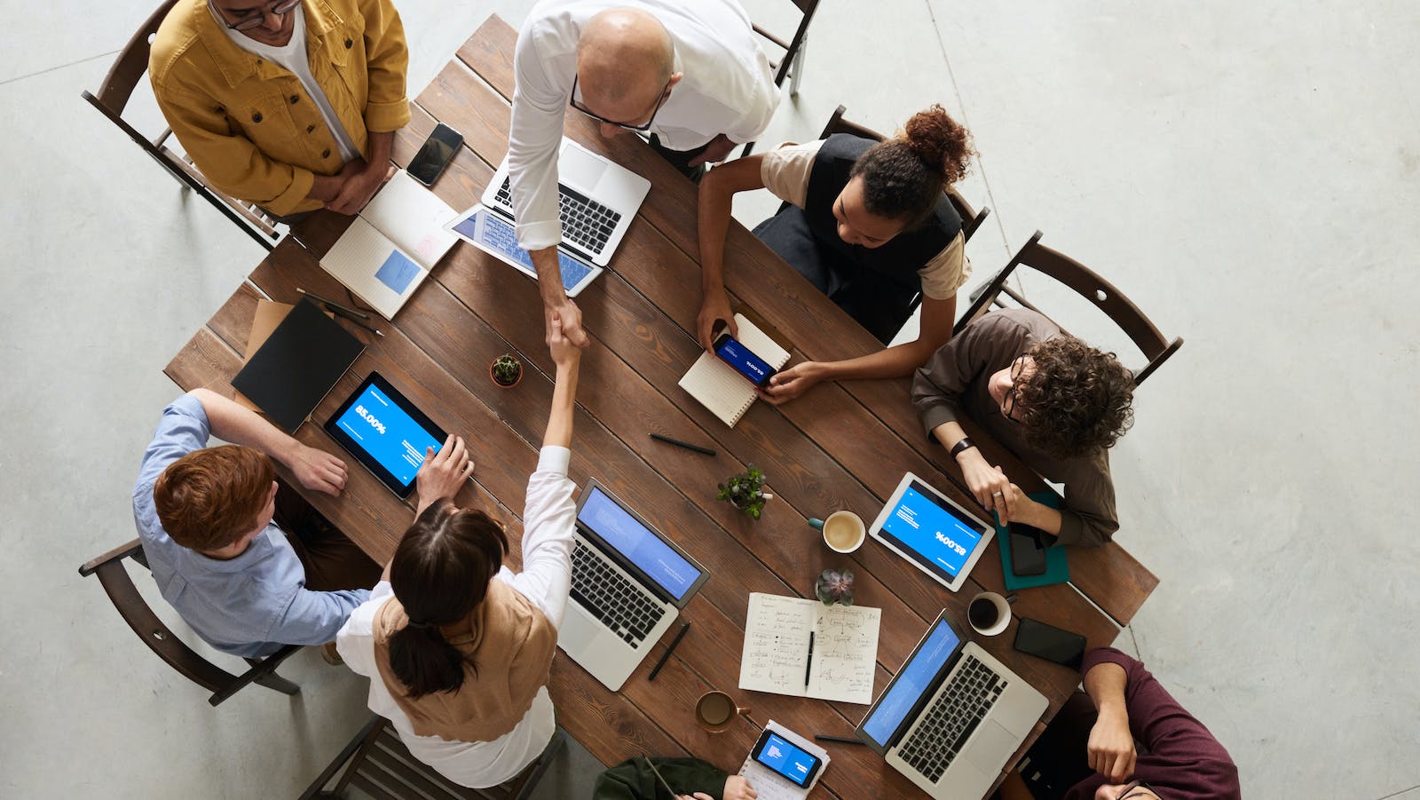 Photo of people shaking hands at a table