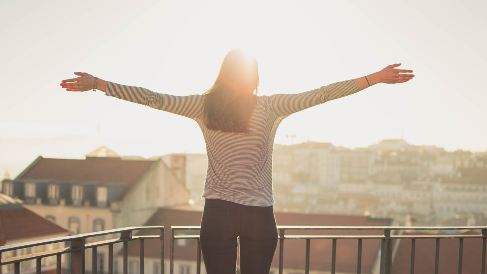 Woman with her arms out on a sunny day