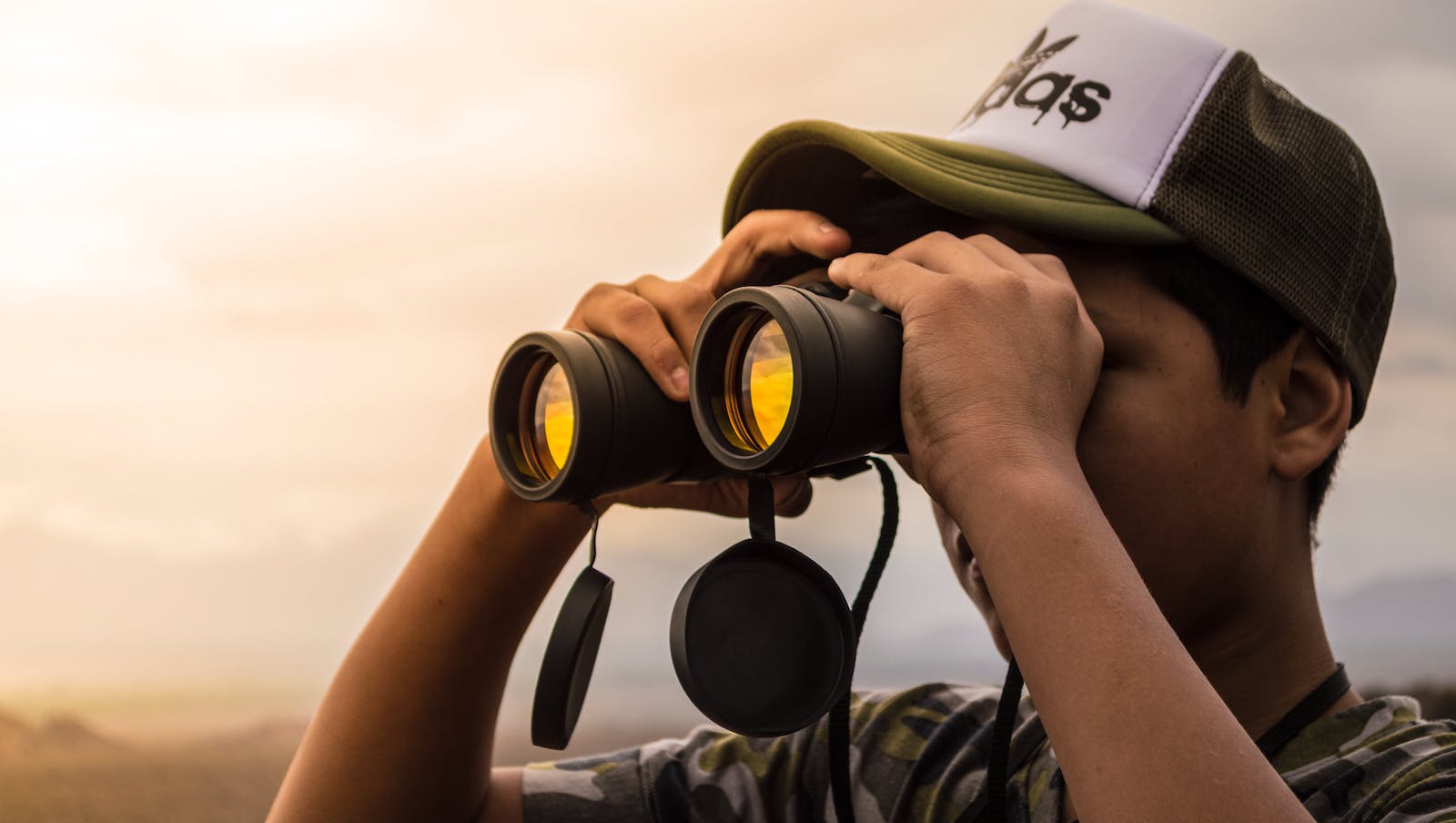 Man Looking in Binoculars during Sunset