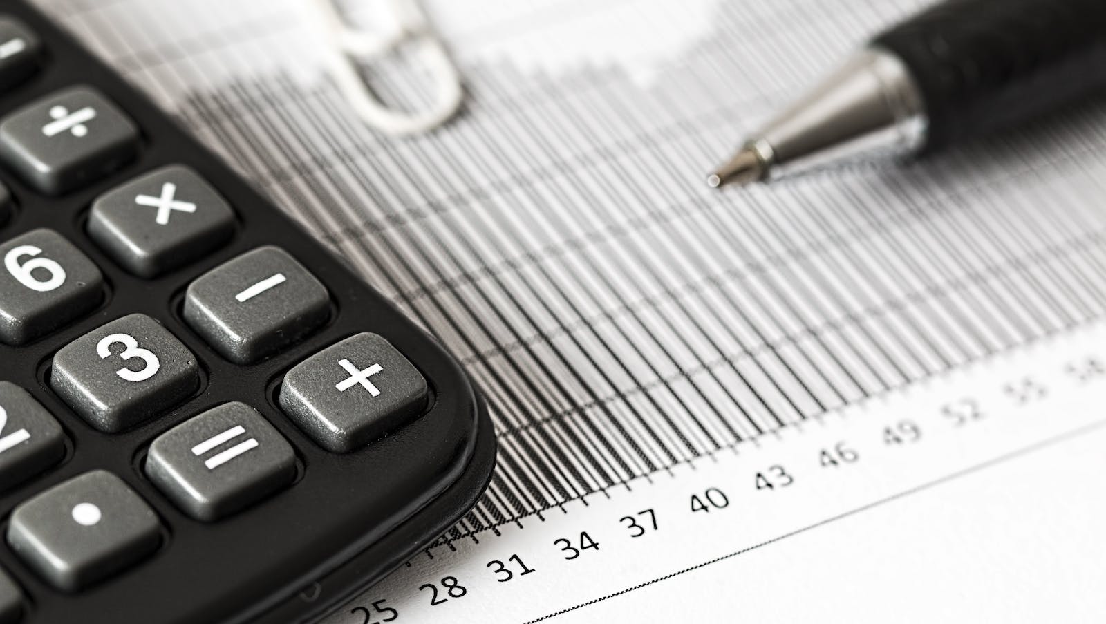 Calculator and Pen on Table