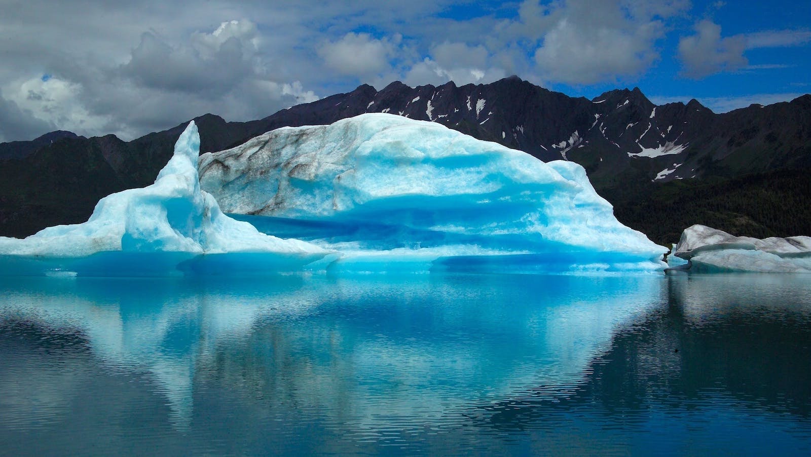 Scenic View of Frozen Lake Against Blue Sky