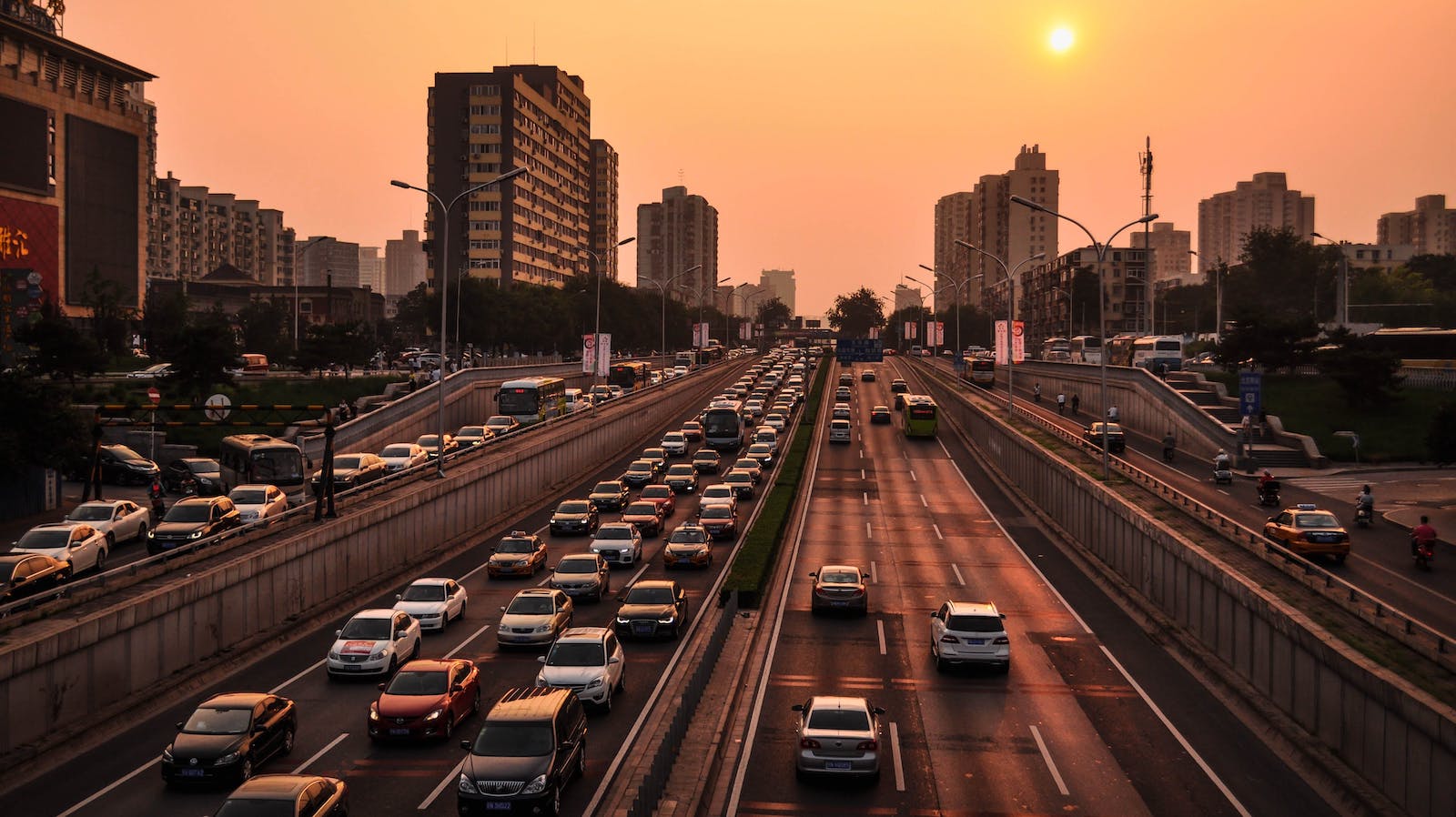 Vehicles on a road at golden hour