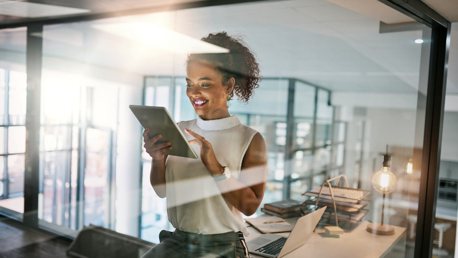 woman looking at ipad and smiling