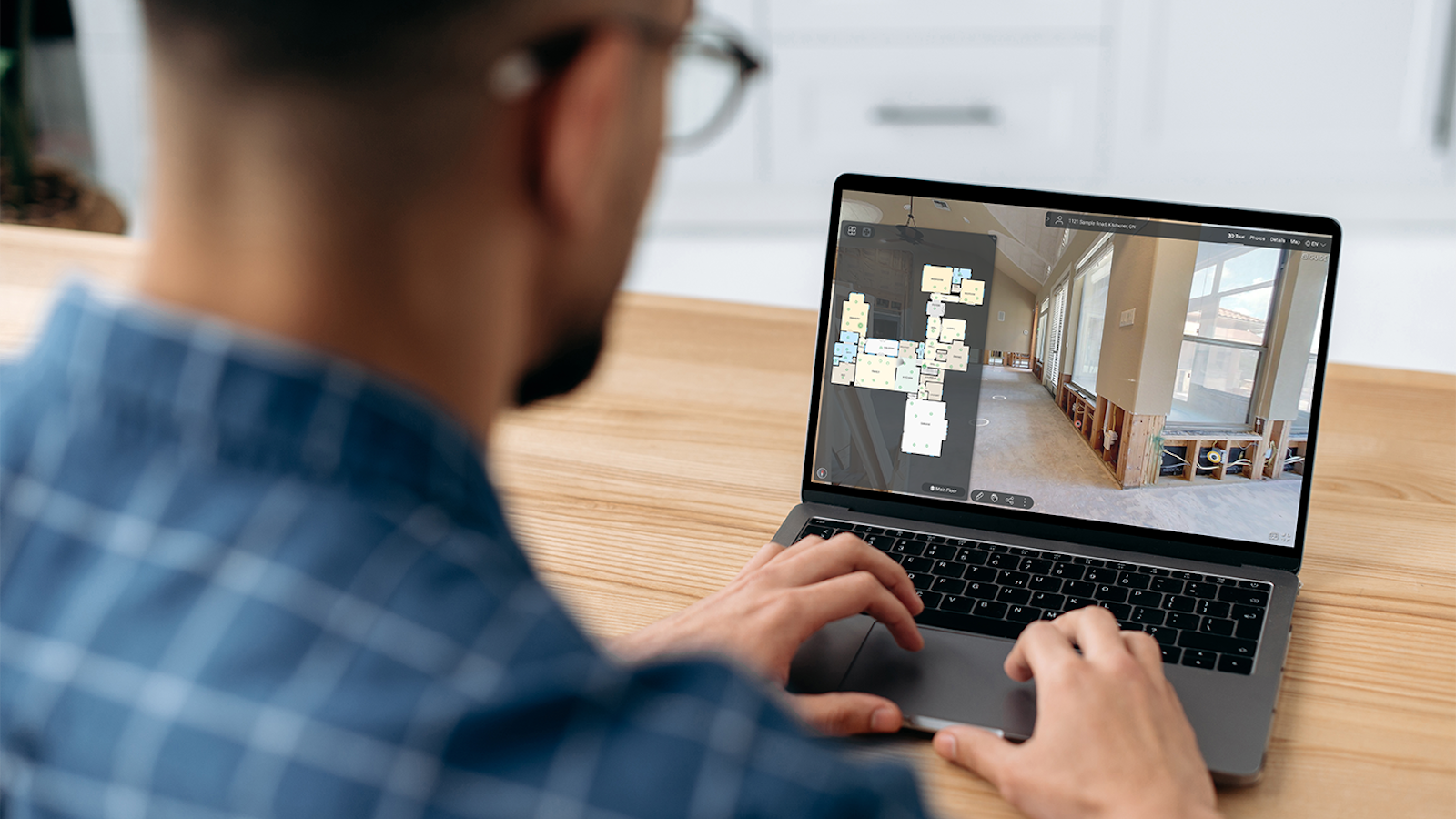 Man looking at blueprint software on laptop