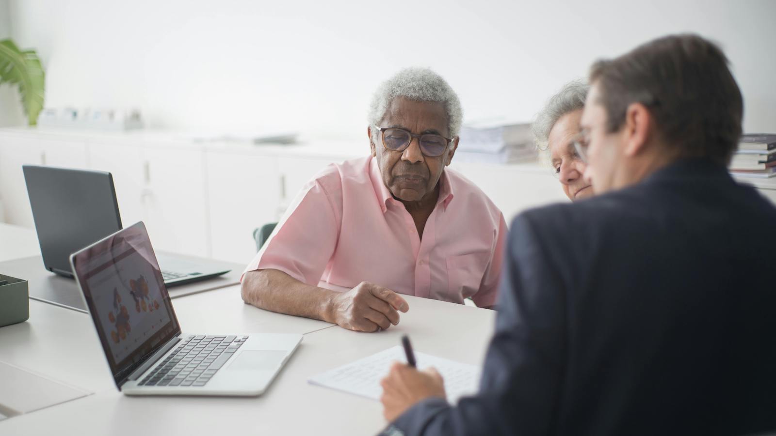 Elderly Couple Discussing Contract with Consultant